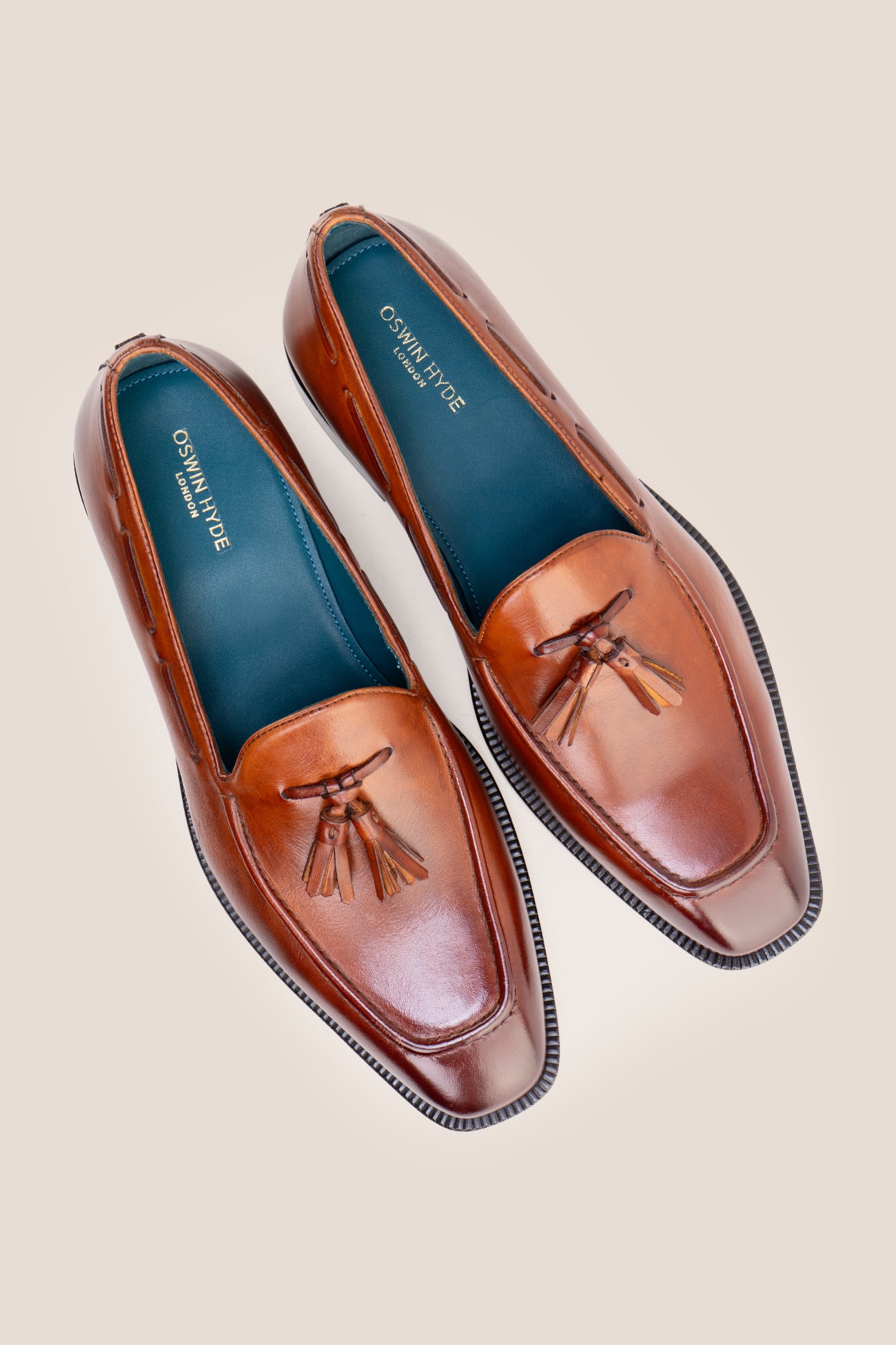 The men's smart tan loafers showcase signature twin tassels and rich full-grain leather, perfect for weddings, business occasions, and summer tailoring.