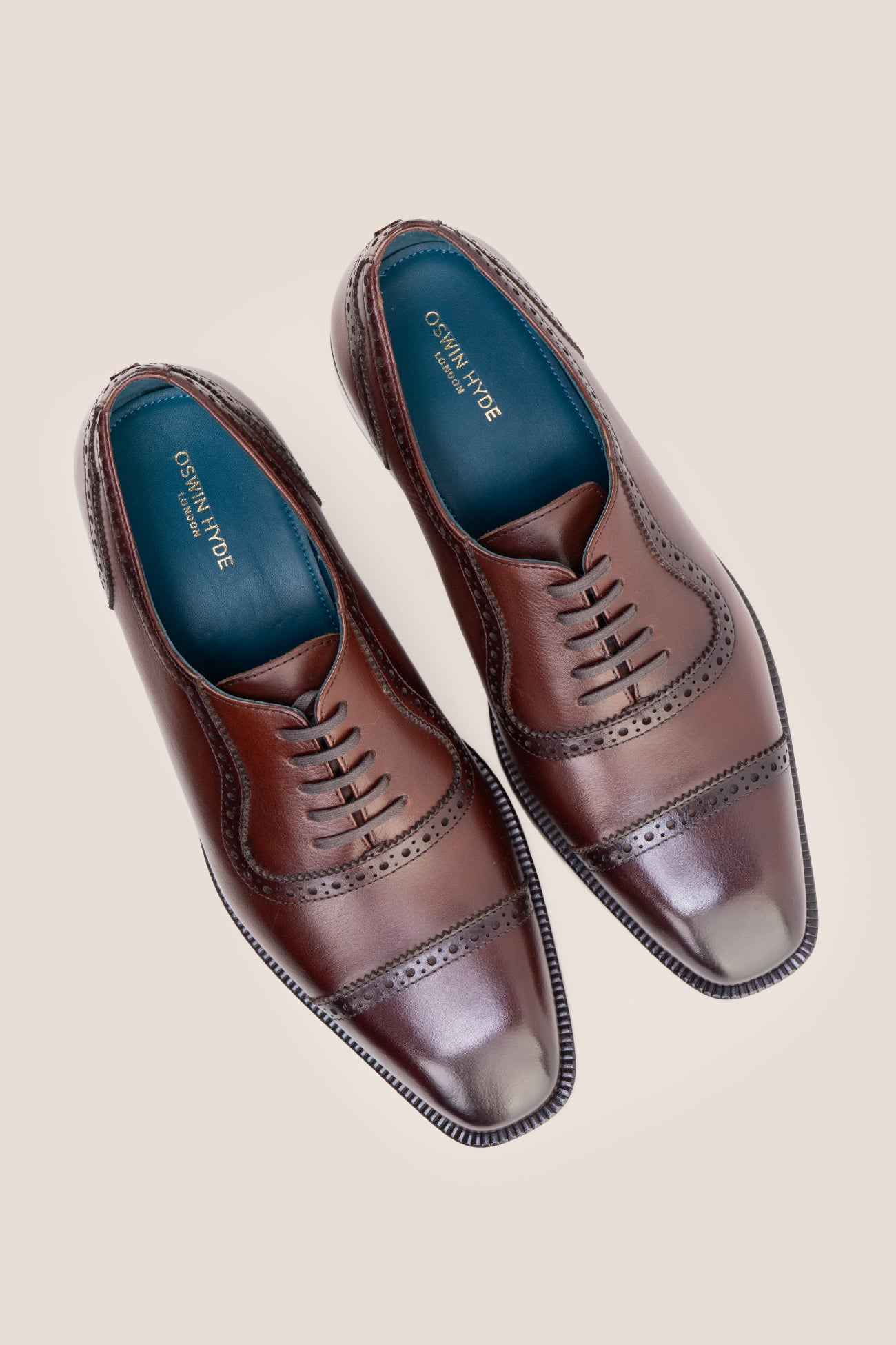 The men's smart brown oxford shoes showcase a refined cap-toe design with delicate brogue detailing and rich full-grain leather, perfect for weddings, formal events, and boardroom attire.
