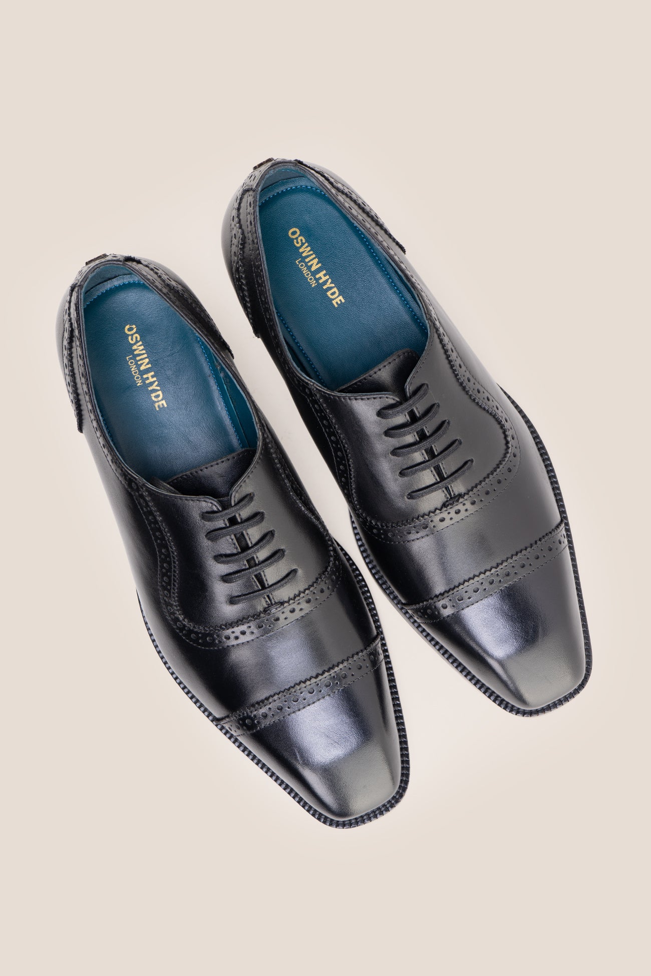 The men's smart black shoes showcase a sleek cap-toe design with delicate brogue punch detailing and premium full-grain leather, perfect for business settings, weddings, and formal occasions.