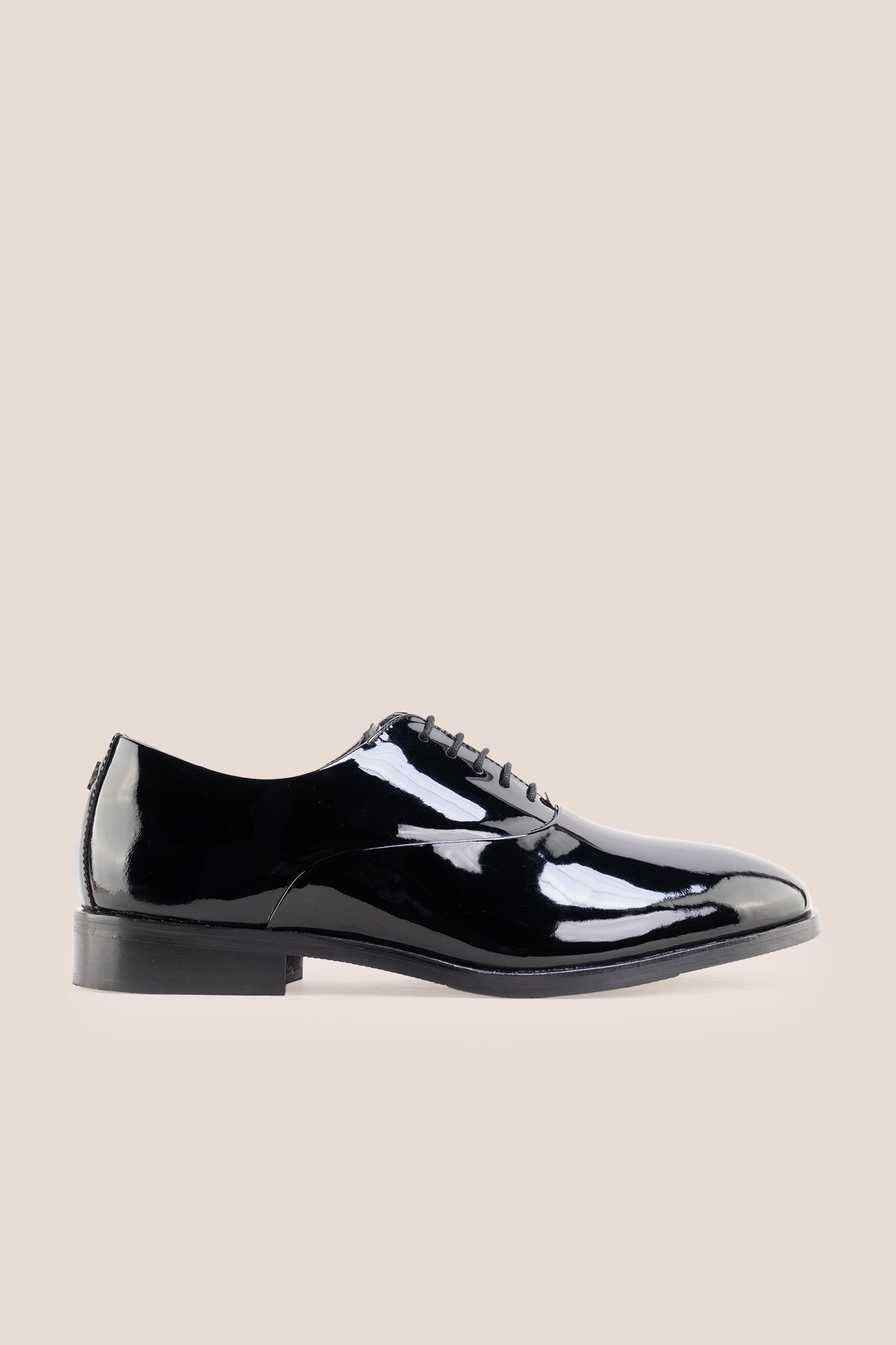 Model wearing Bow Black men's leather patent shoes. The men's smart black shoes exude luxury and sophistication, perfect for weddings