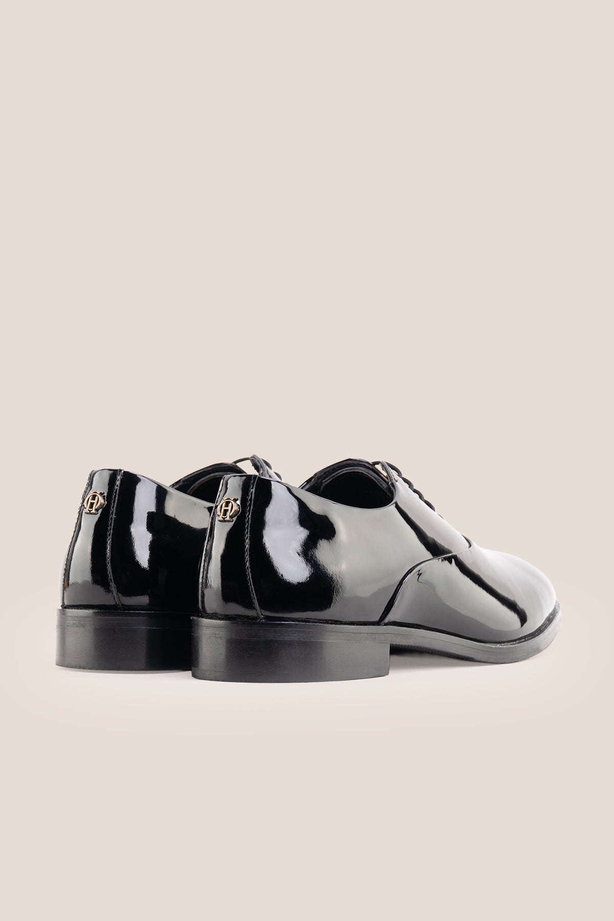 Model wearing Bow Black men's leather patent shoes. The men's smart black shoes exude luxury and sophistication, perfect for weddings