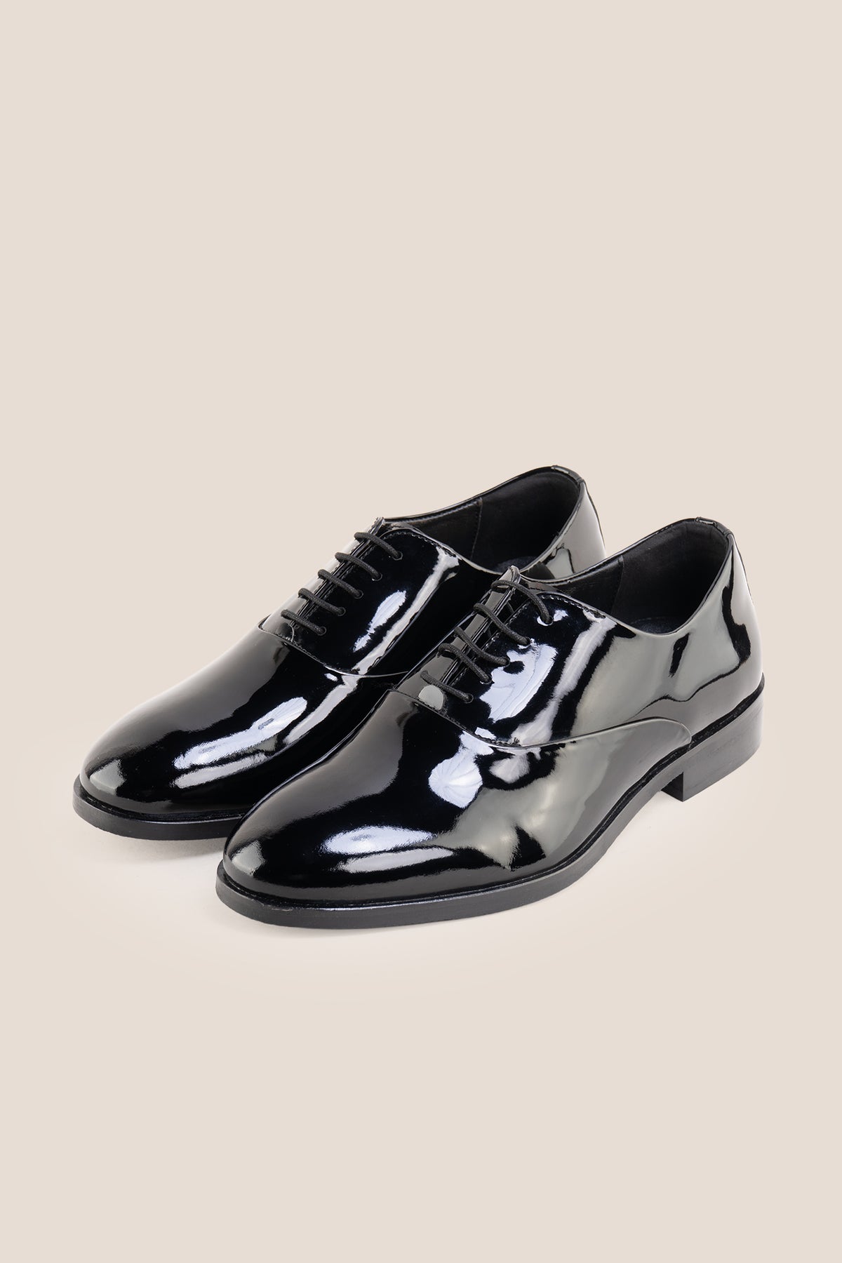 Model wearing Bow Black men's leather patent shoes. The men's smart black shoes exude luxury and sophistication, perfect for weddings