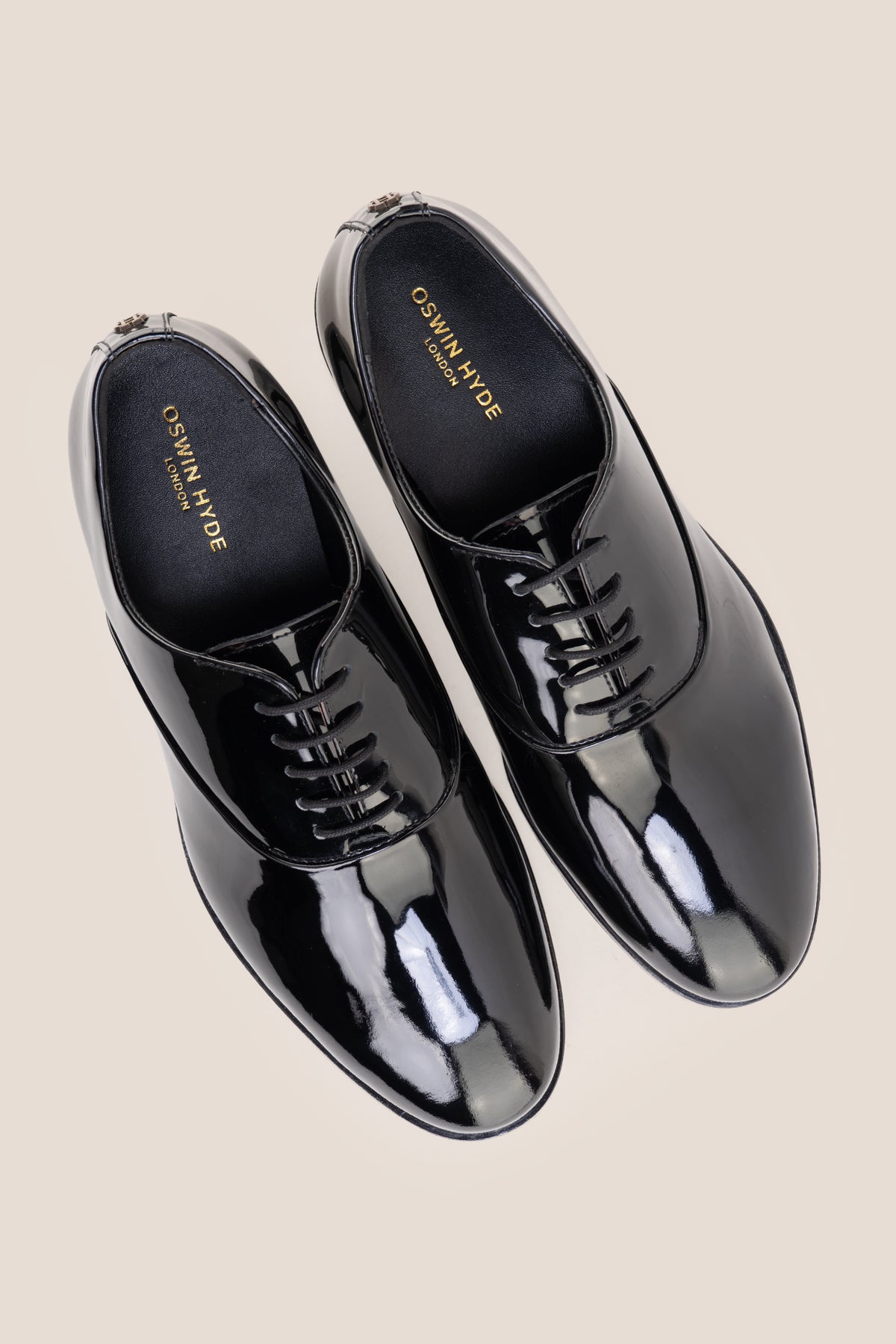 Model wearing Bow Black men's leather patent shoes. The men's smart black shoes exude luxury and sophistication, perfect for weddings