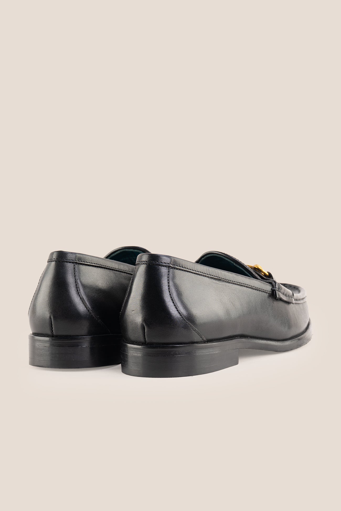 Pair of Oswin Hyde Samuel black leather horsebit loafers with gold buckle detail and teal lining.