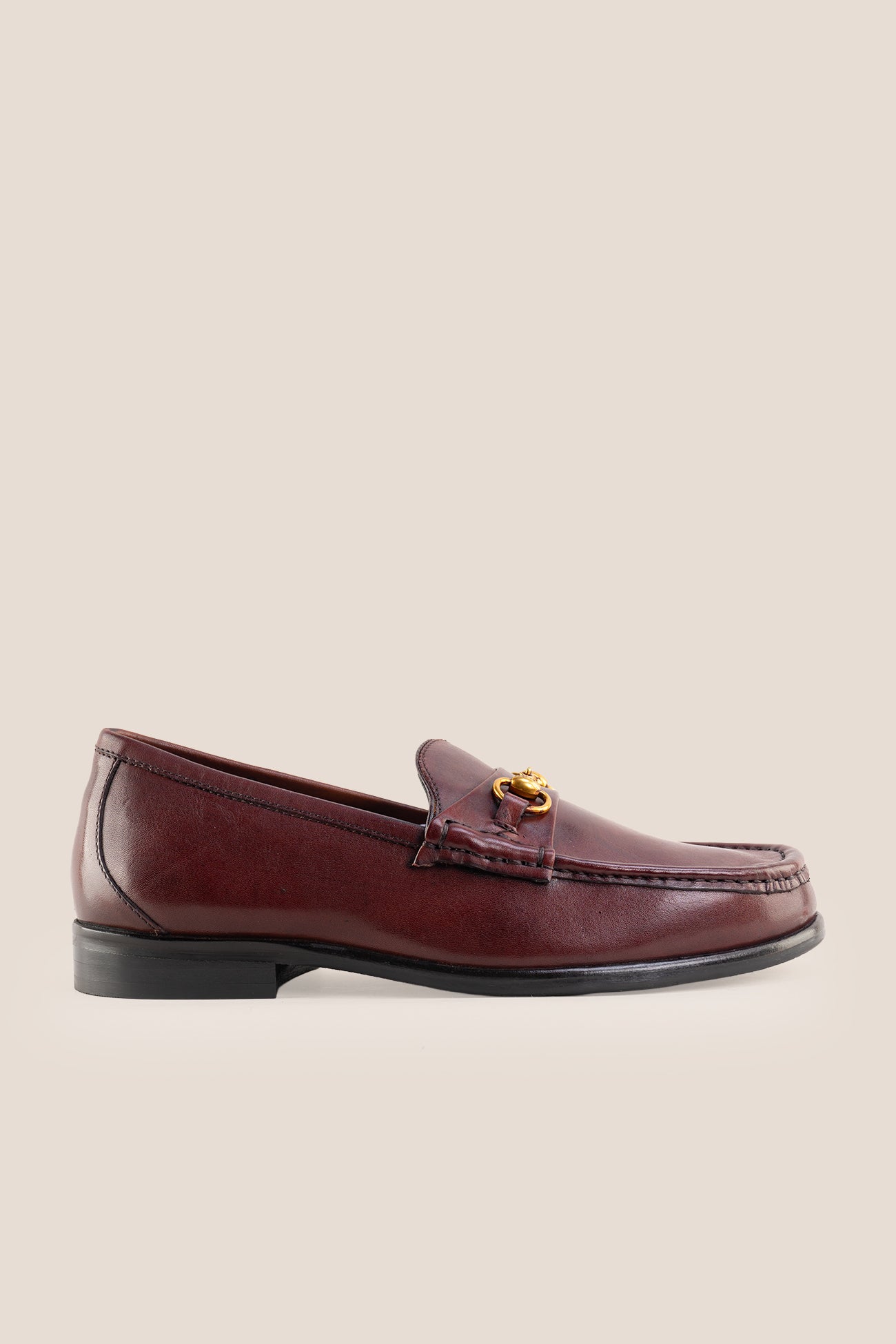 Pair of Oswin Hyde Samuel Bordo burgundy leather horsebit loafers with gold buckle detail and teal lining.