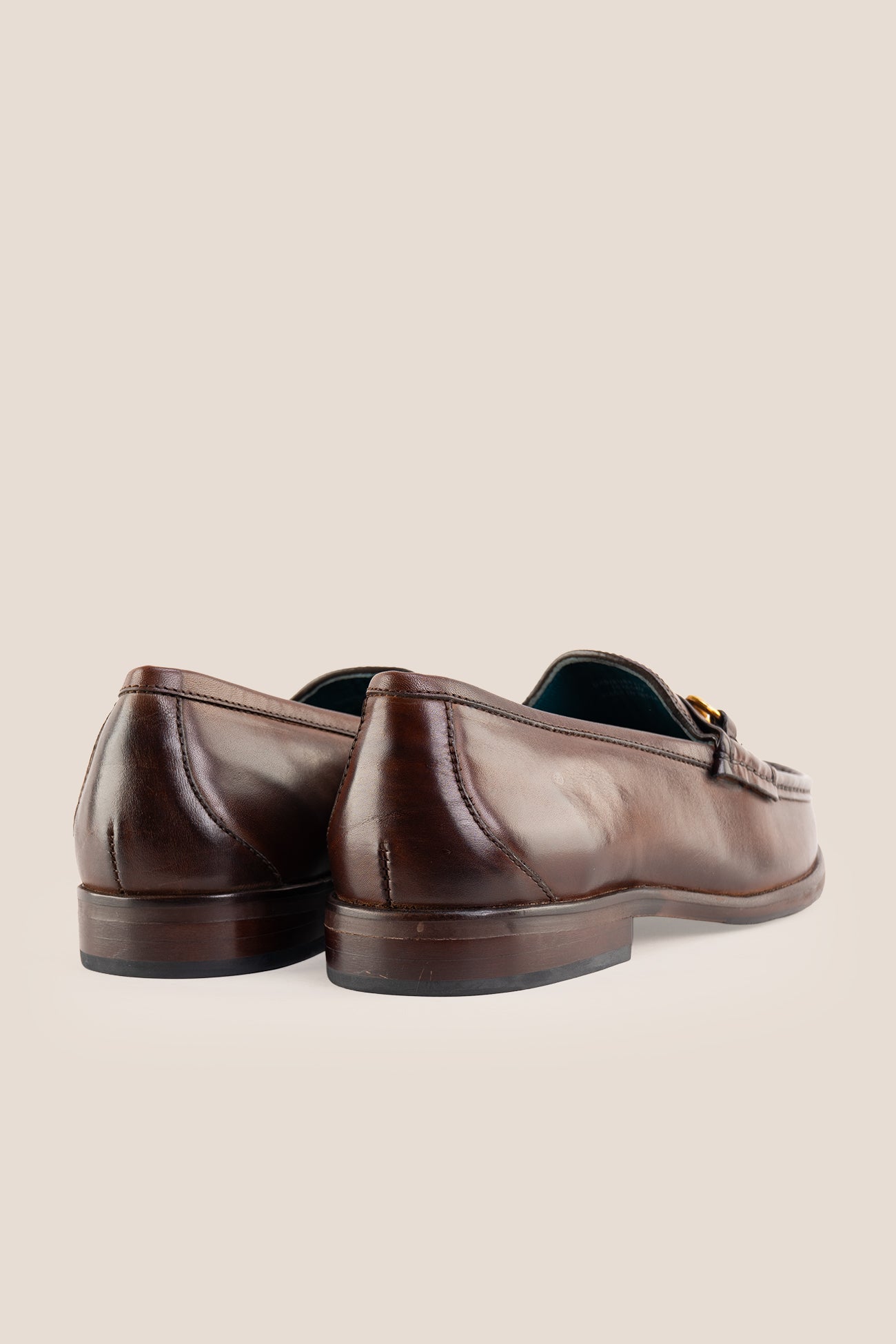 Pair of Oswin Hyde Samuel dark brown leather horsebit loafers with gold buckle detail and teal lining.