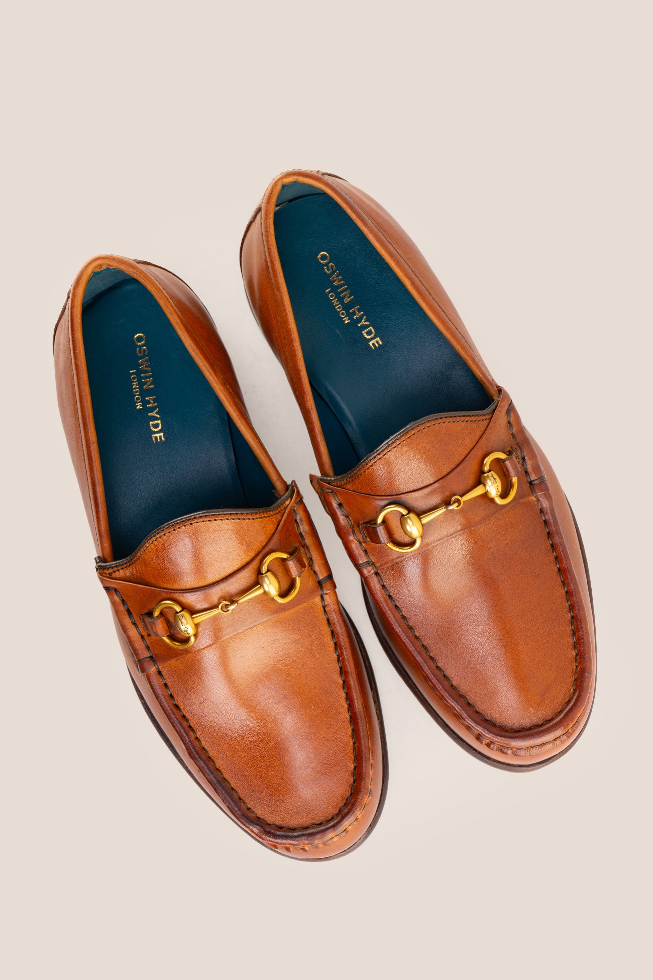 Pair of Oswin Hyde Samuel Tan leather horsebit loafers featuring gold bit hardware.