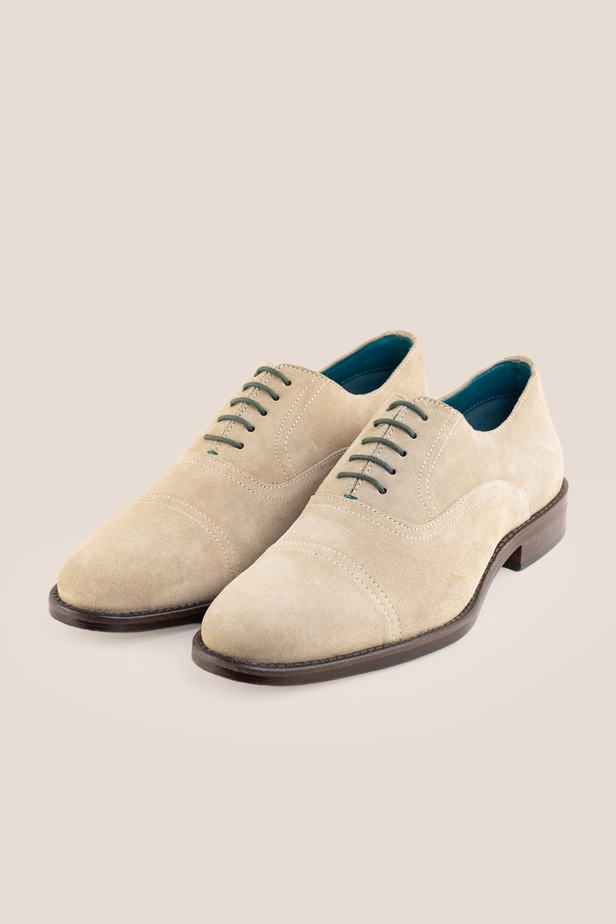 Model wearing Elise Sand men's sand suede Oxford shoes