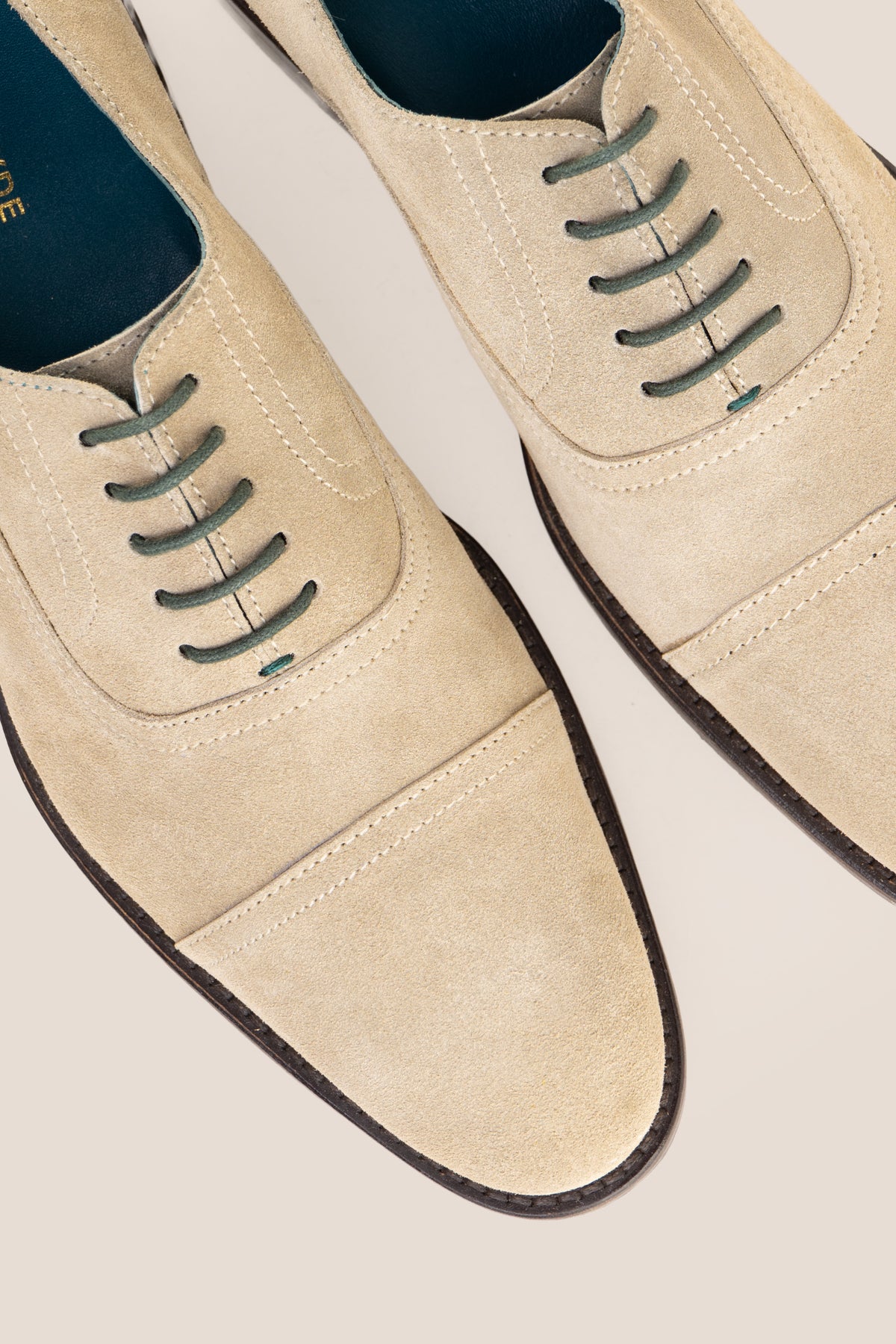 Model wearing Elise Sand men's sand suede Oxford shoes