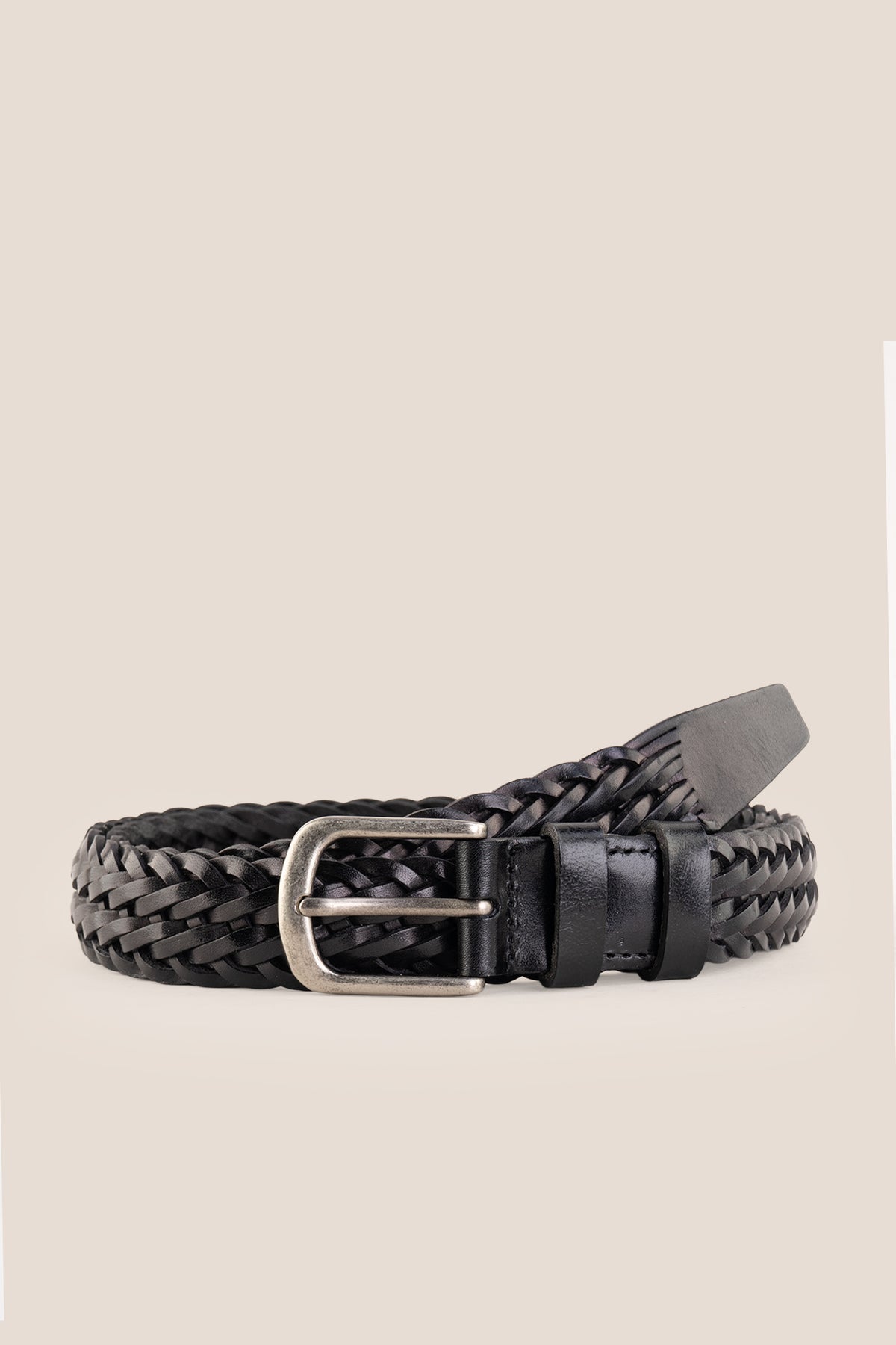 Milo black braided leather belt coiled with brushed silver buckle on neutral background