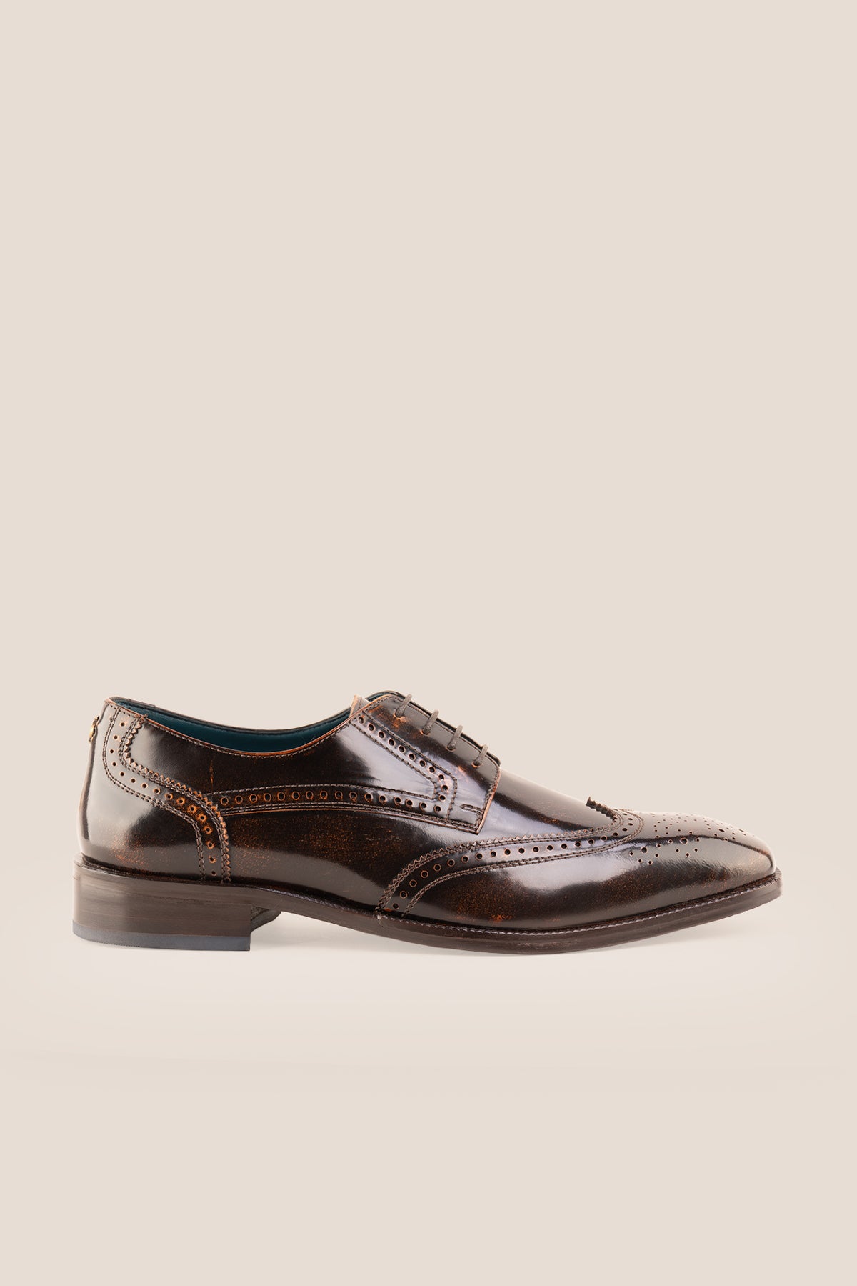 Men's Gabriel Tan leather wingtip Derby dress shoes by Oswin Hyde featuring burnished tan leather and lace-up closure.