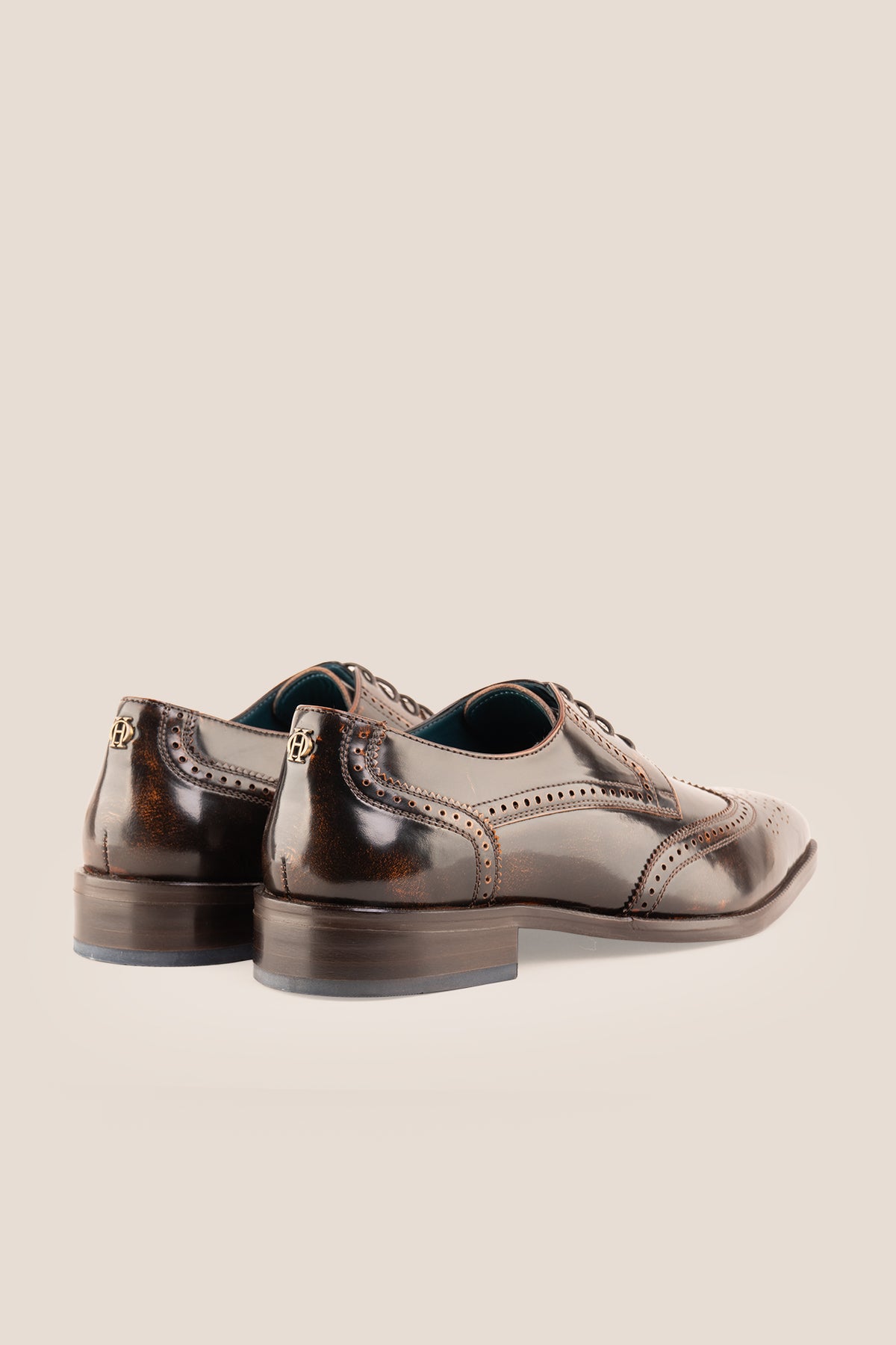 Men's Gabriel Tan leather wingtip Derby dress shoes by Oswin Hyde featuring burnished tan leather and lace-up closure.