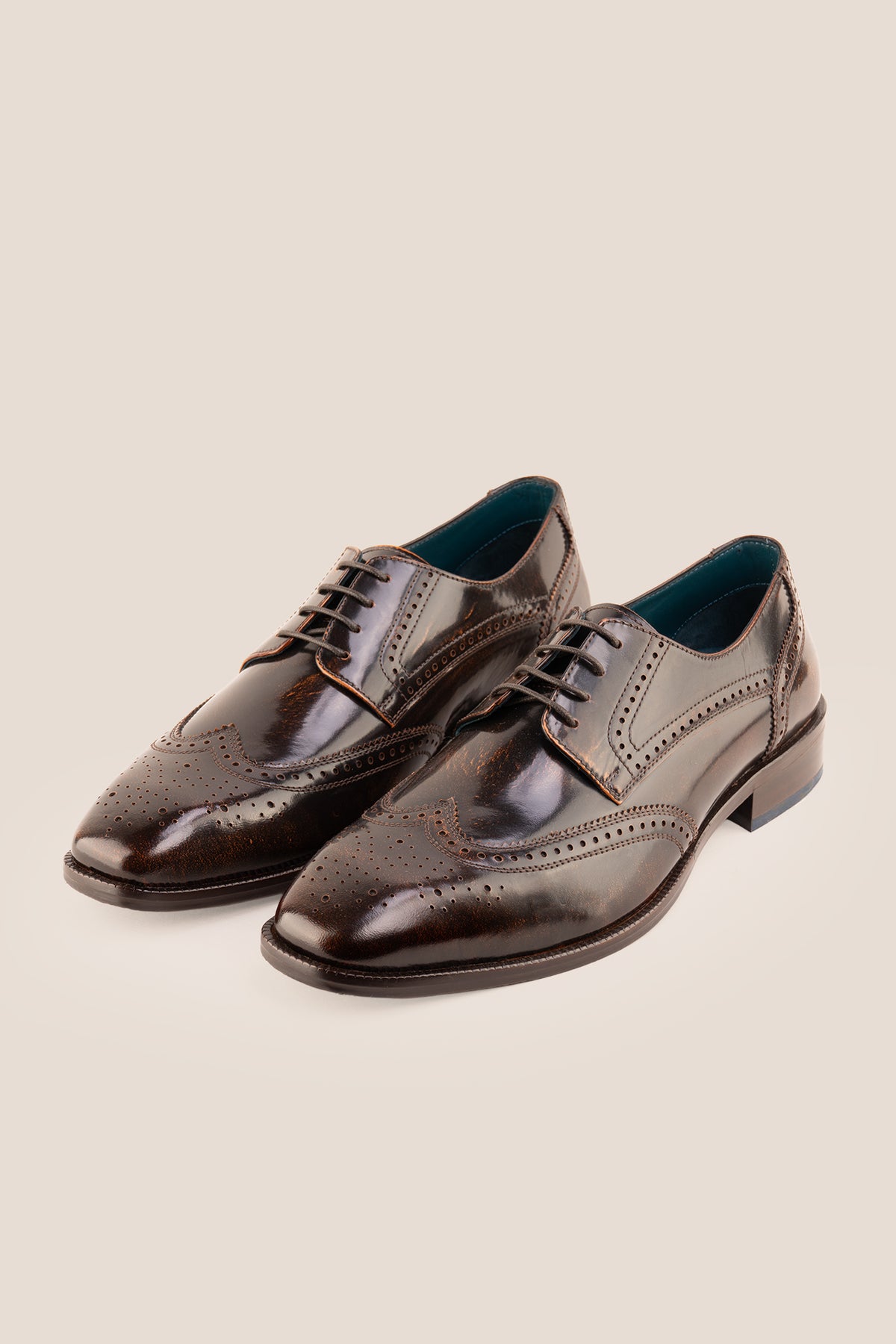 Men's Gabriel Tan leather wingtip Derby dress shoes by Oswin Hyde featuring burnished tan leather and lace-up closure.