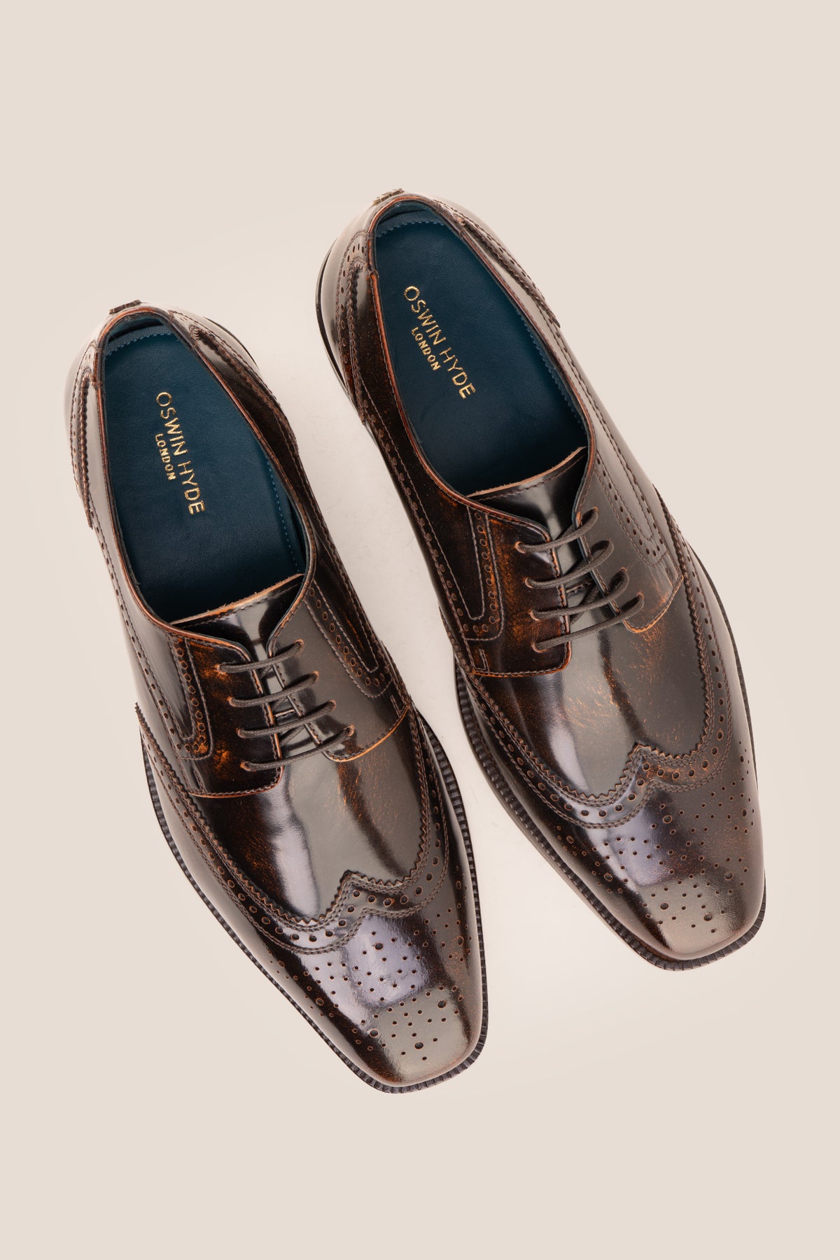 Men's Gabriel Tan leather wingtip Derby dress shoes by Oswin Hyde featuring burnished tan leather and lace-up closure.