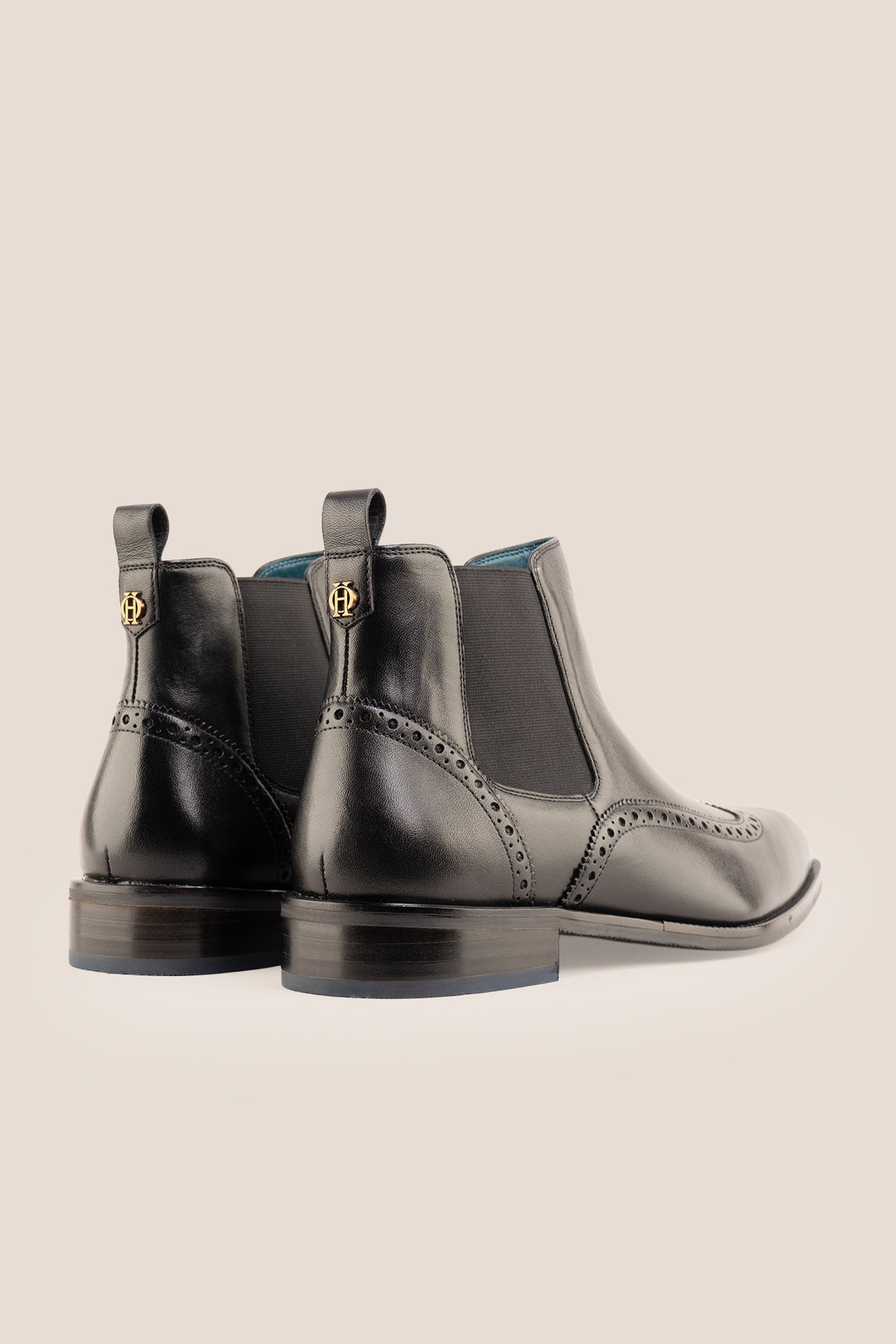 Men's Edgar Black leather brogue Chelsea boots by Oswin Hyde featuring wingtip detailing and elastic side gussets.