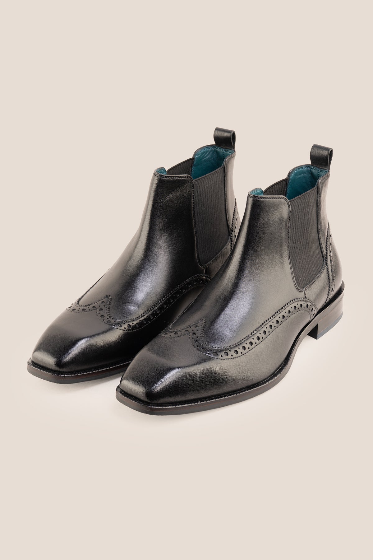 Men's Edgar Black leather brogue Chelsea boots by Oswin Hyde featuring wingtip detailing and elastic side gussets.