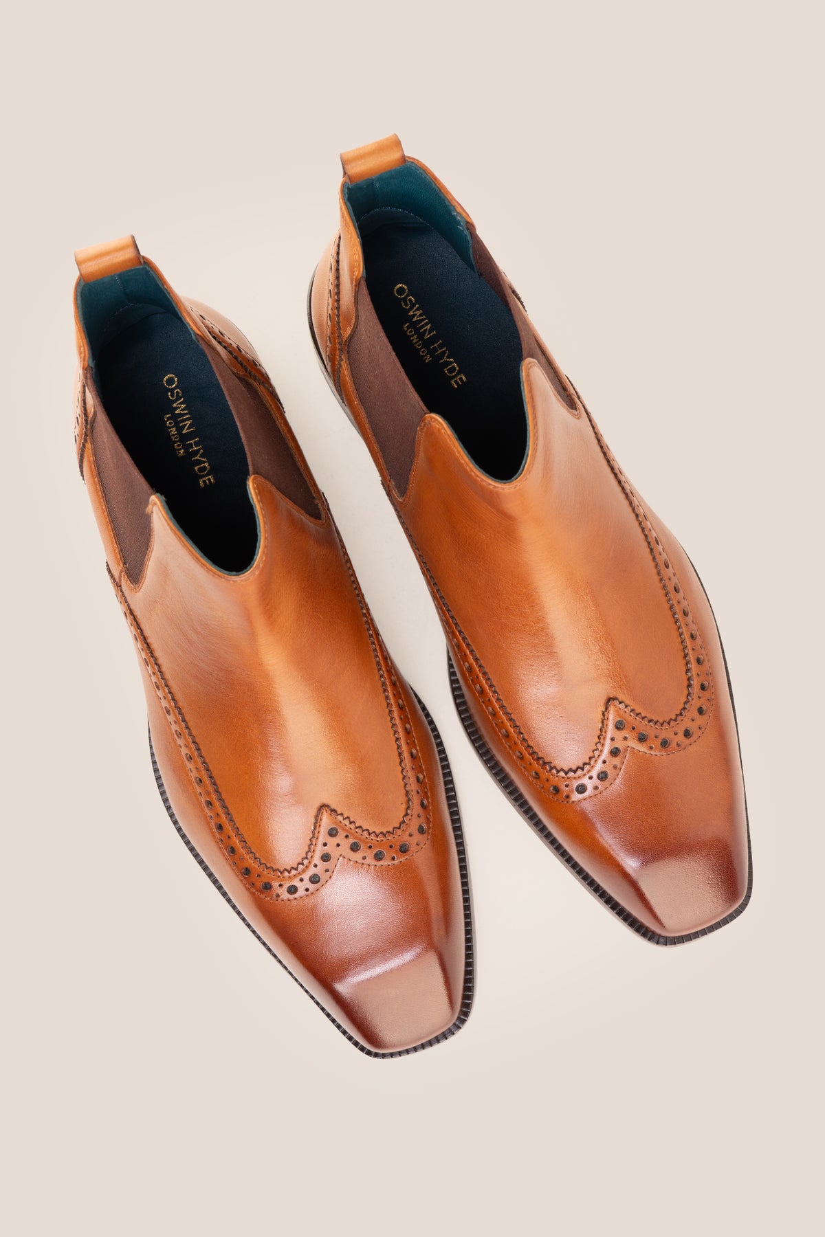 Men's Edgar Tan leather brogue Chelsea boots by Oswin Hyde featuring wingtip detailing and elastic side gussets.
