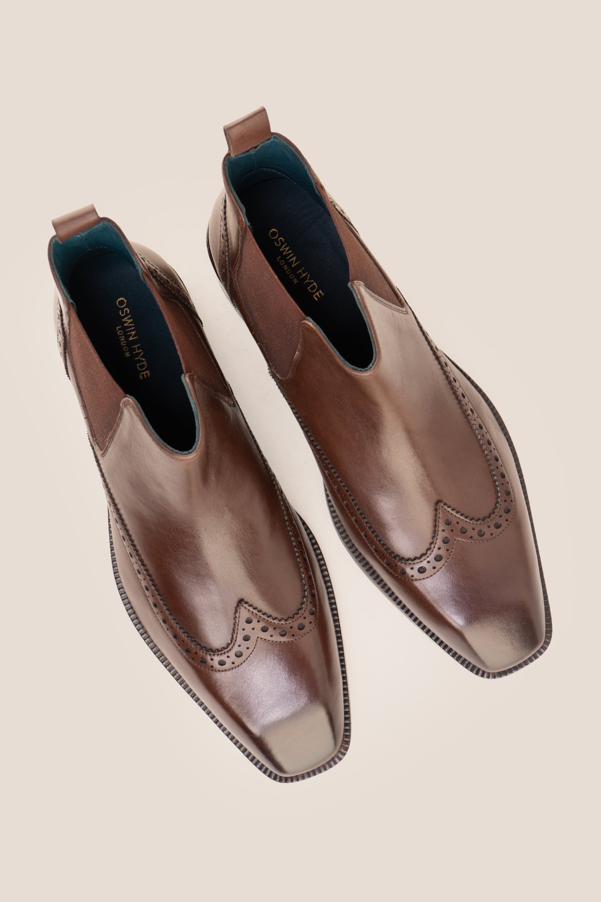 Men's Edgar Brown leather brogue Chelsea boots by Oswin Hyde featuring wingtip detailing and elastic side gussets.