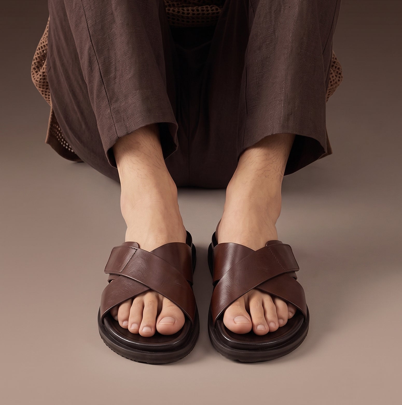 Model wearing Dylan Brown leather men’s sandals with cross strap and velcro closure, perfect for casual wear, holidays, or summer outings.