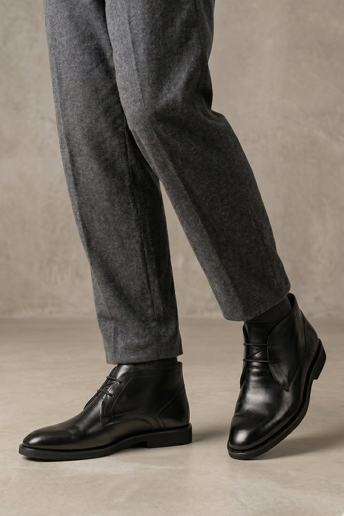 Man wearing Jefferson Black Chukka boots for men made from high-quality saffiano leather, offering bold elegance, casual versatility, and modern sophistication.