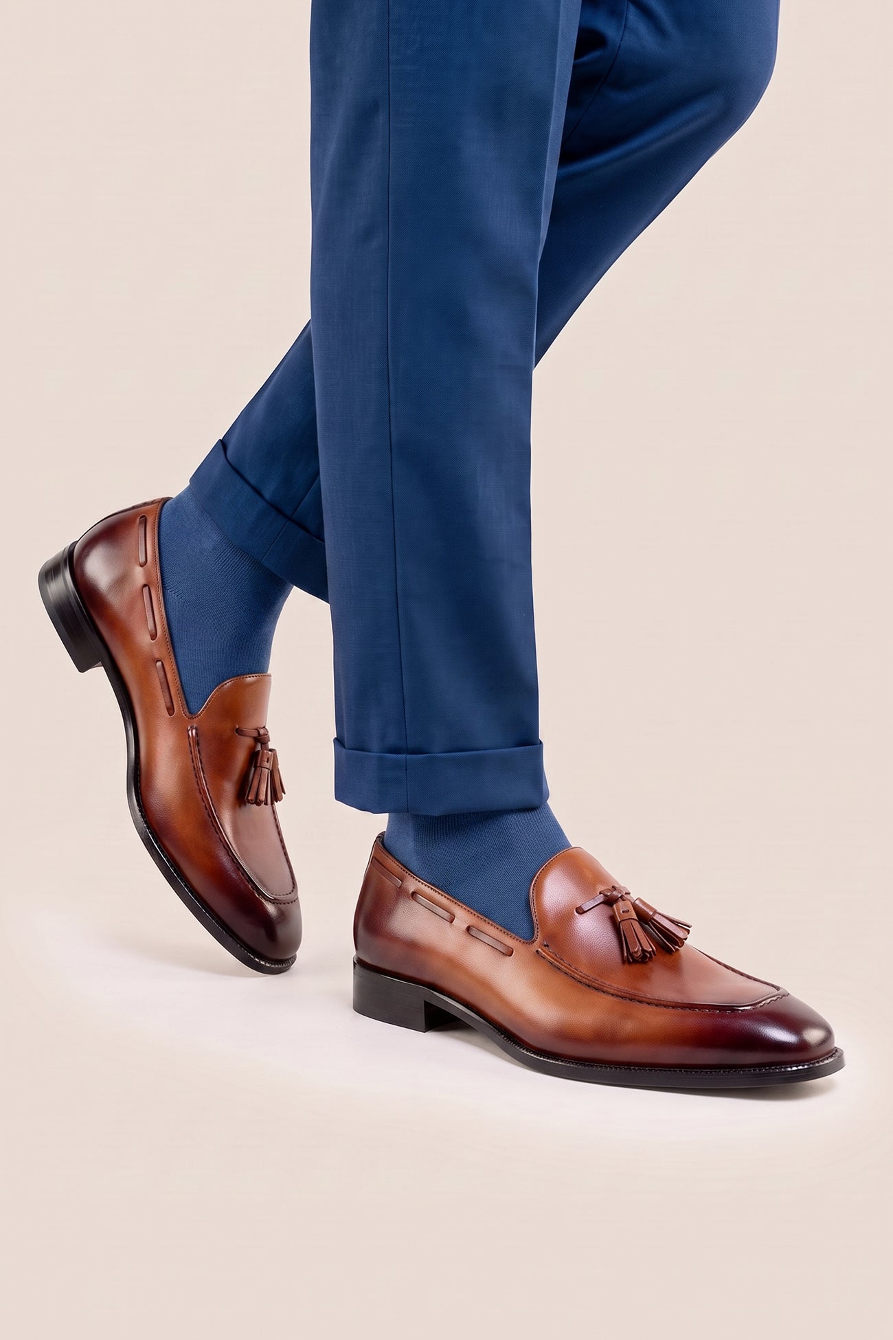 The men's smart tan loafers showcase signature twin tassels and rich full-grain leather, perfect for weddings, business occasions, and summer tailoring.