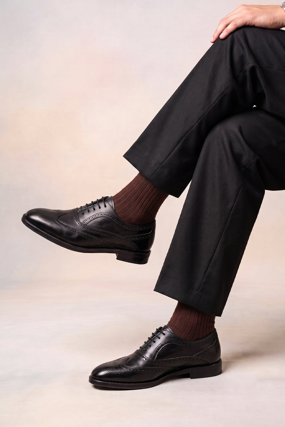 Model wearing Premium solid socks designed by Oswin Hyde for the discerning gentleman.
