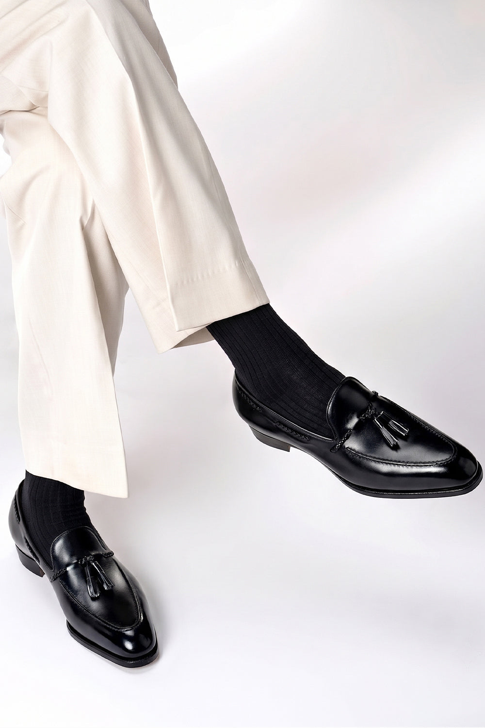 Model wearing Premium black cotton socks designed by Oswin Hyde for the discerning gentleman.