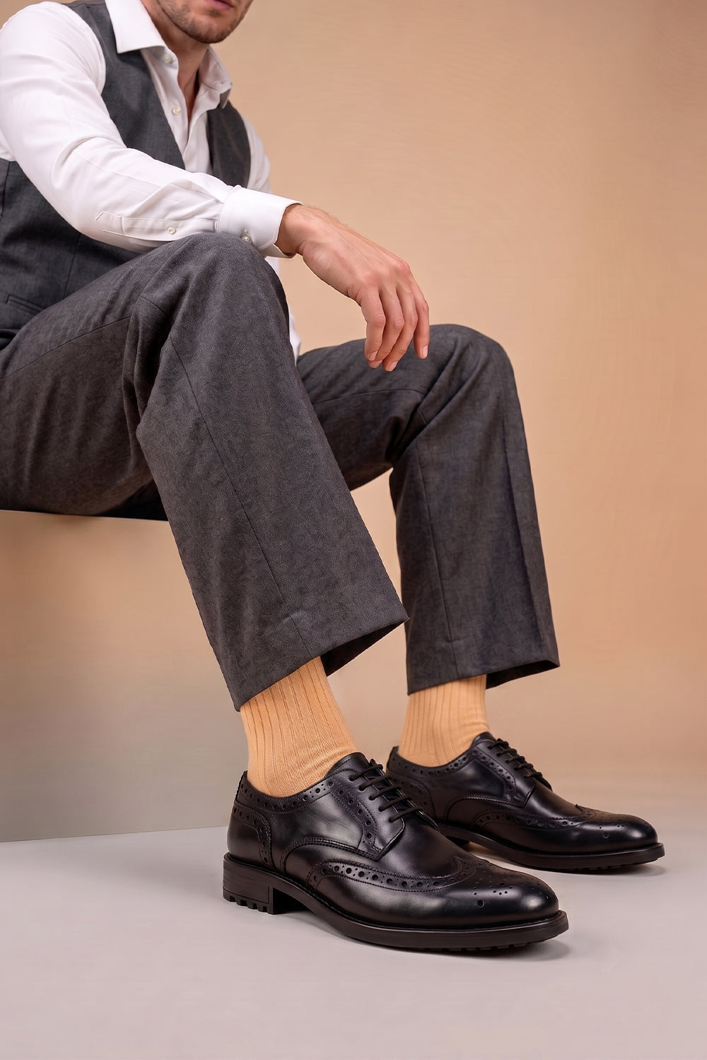 Model wearing Premium solid socks designed by Oswin Hyde for the discerning gentleman.