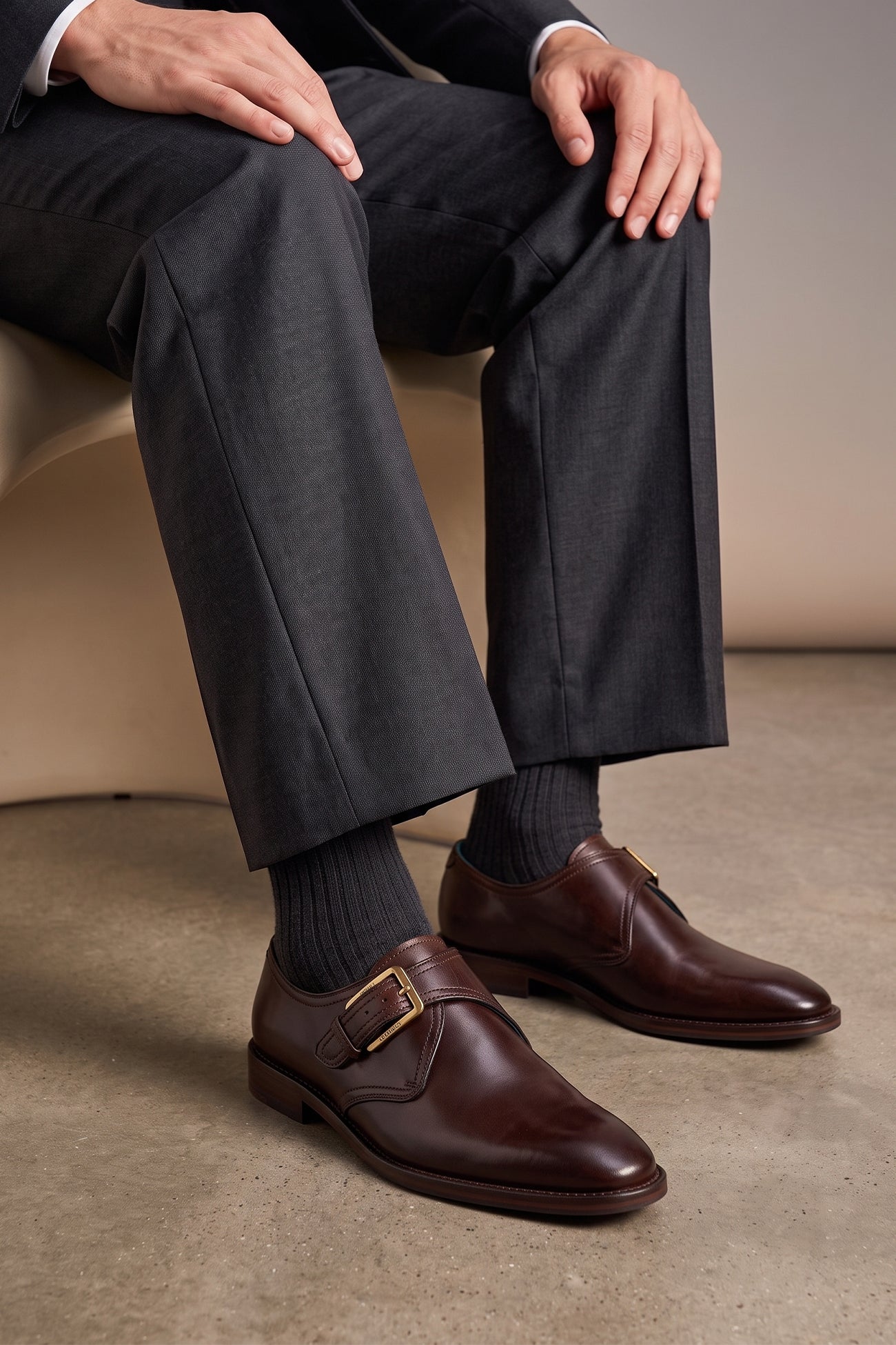 Man wearing Premium men's brown leather single monk strap dress shoes by Oswin Hyde London featuring a plain toe, adjustable golden buckle, contrast sole stitching, and a cushioned teal interior.