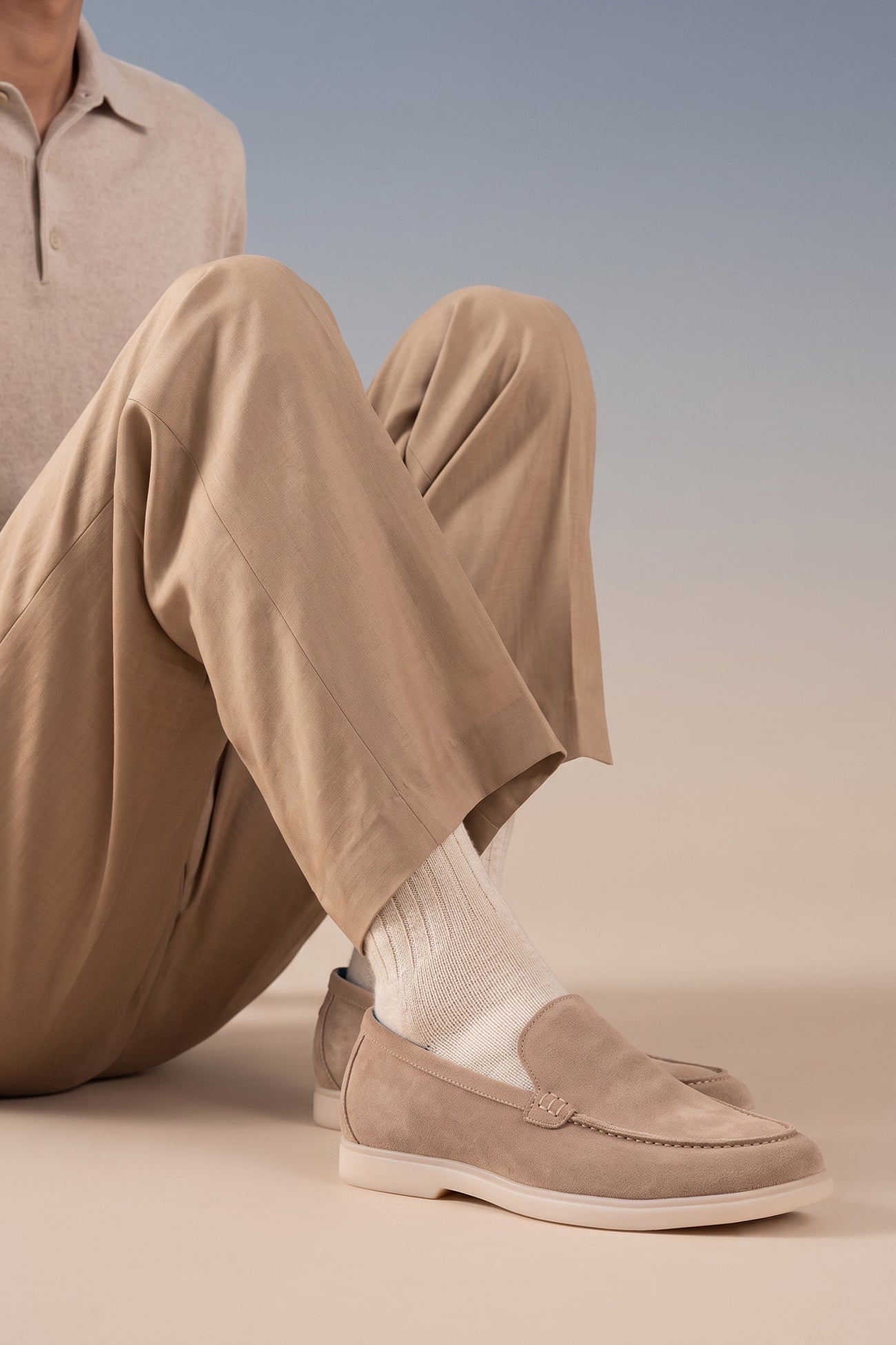 Model wearing Oswin Hyde Morgan Sand Suede. These premium men’s suede loafers are a summer essential for casual and smart-casual looks. Discover comfort and timeless style today.