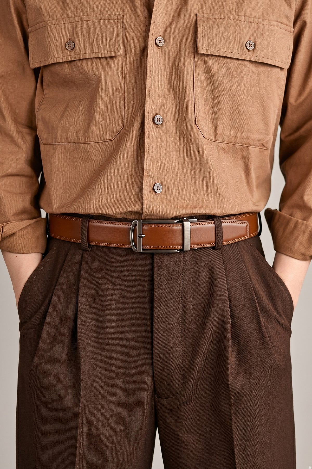 Man wearing Men’s Nelson tan premium leather automatic belt with ratchet closure for adjustable fit and elegant style, suitable for formal and casual wear.