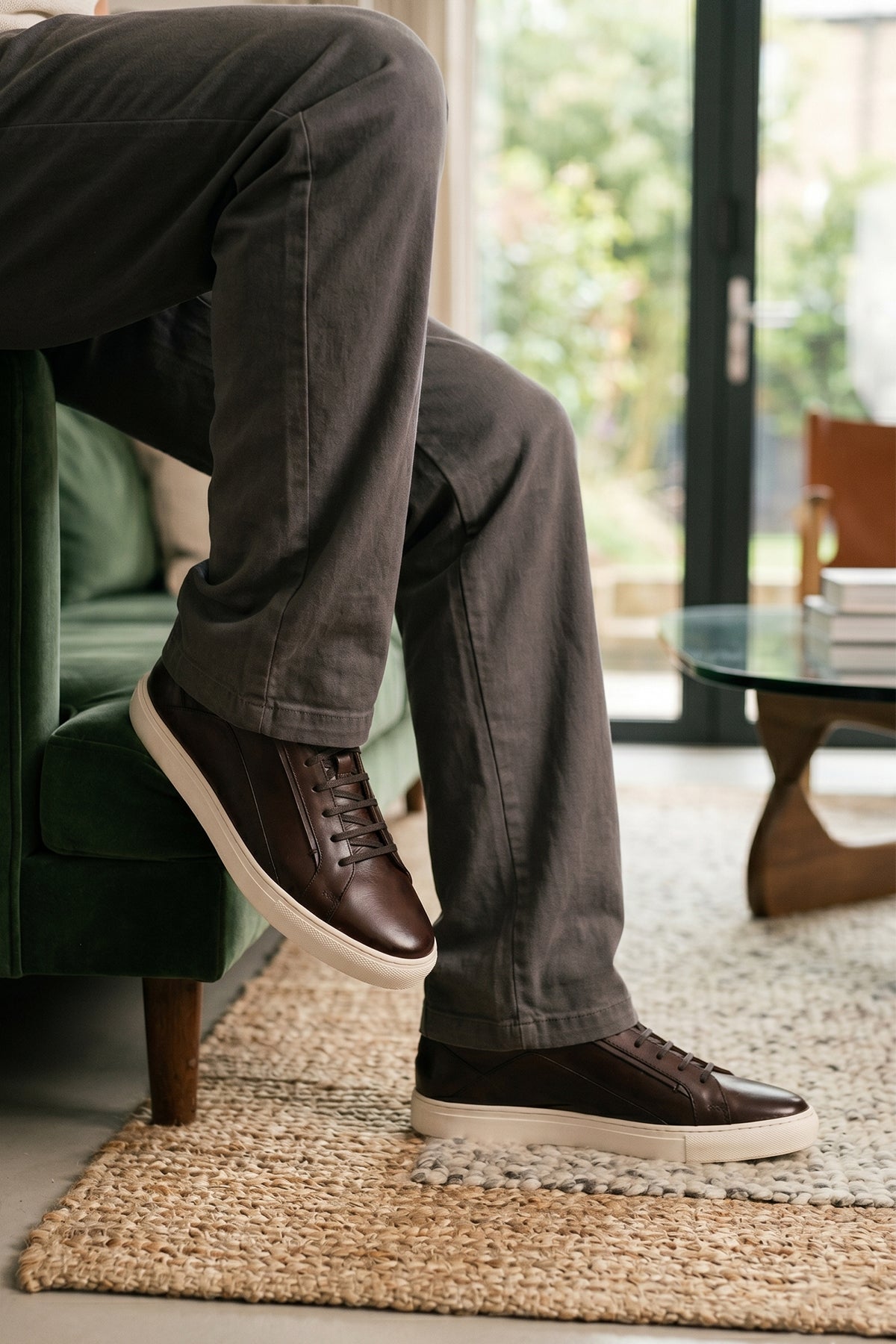 Model wearing Hayes Brown leather sneakers for men, designed with a classic seven-eyelet style that enhances your everyday attire. Made from premium leather