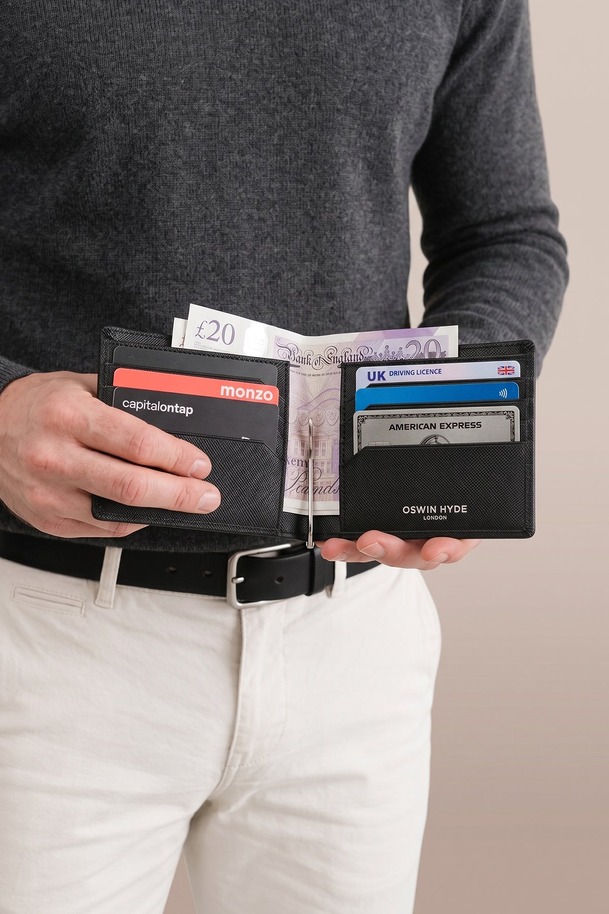 Man holding Sloane black saffiano leather money clip for men by Oswin Hyde – sleek luxury design with silver embossing for elegant, minimal everyday use.