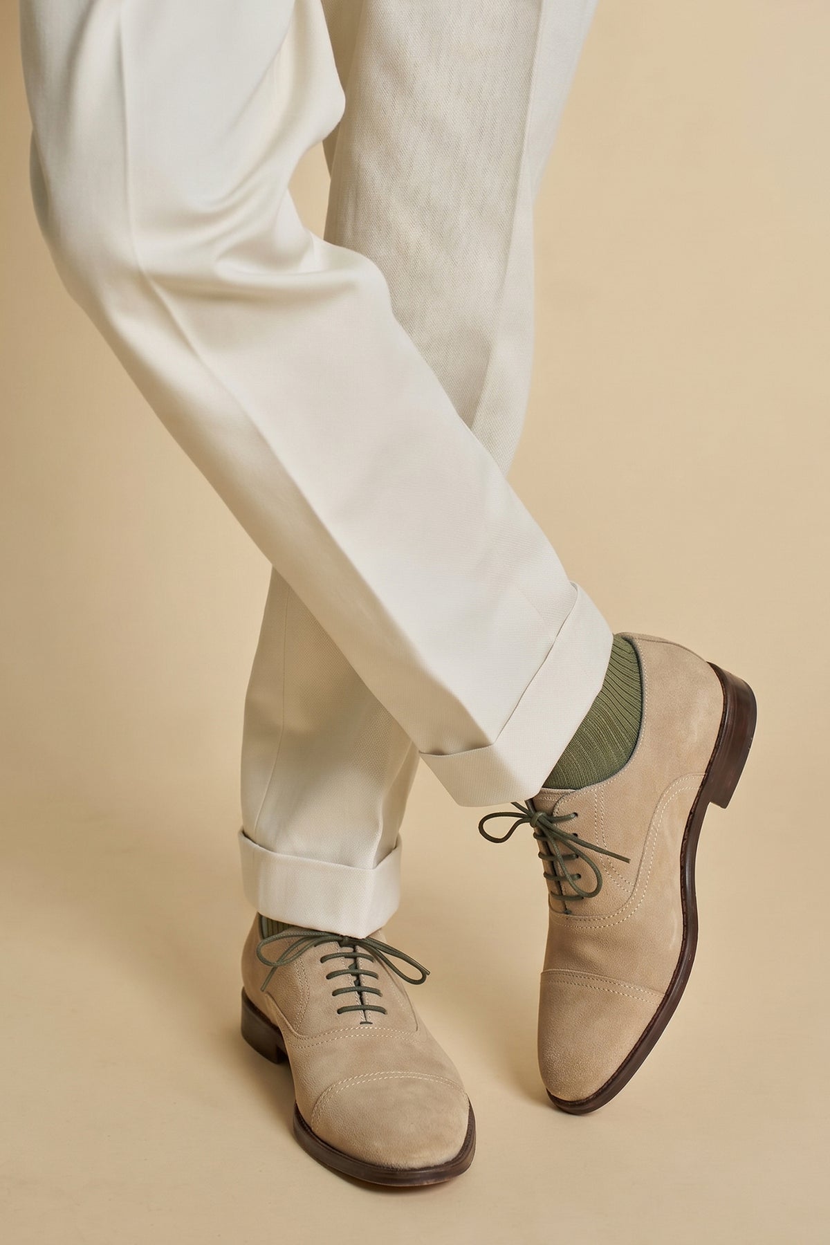 Model wearing Elise Sand men's sand suede Oxford shoes