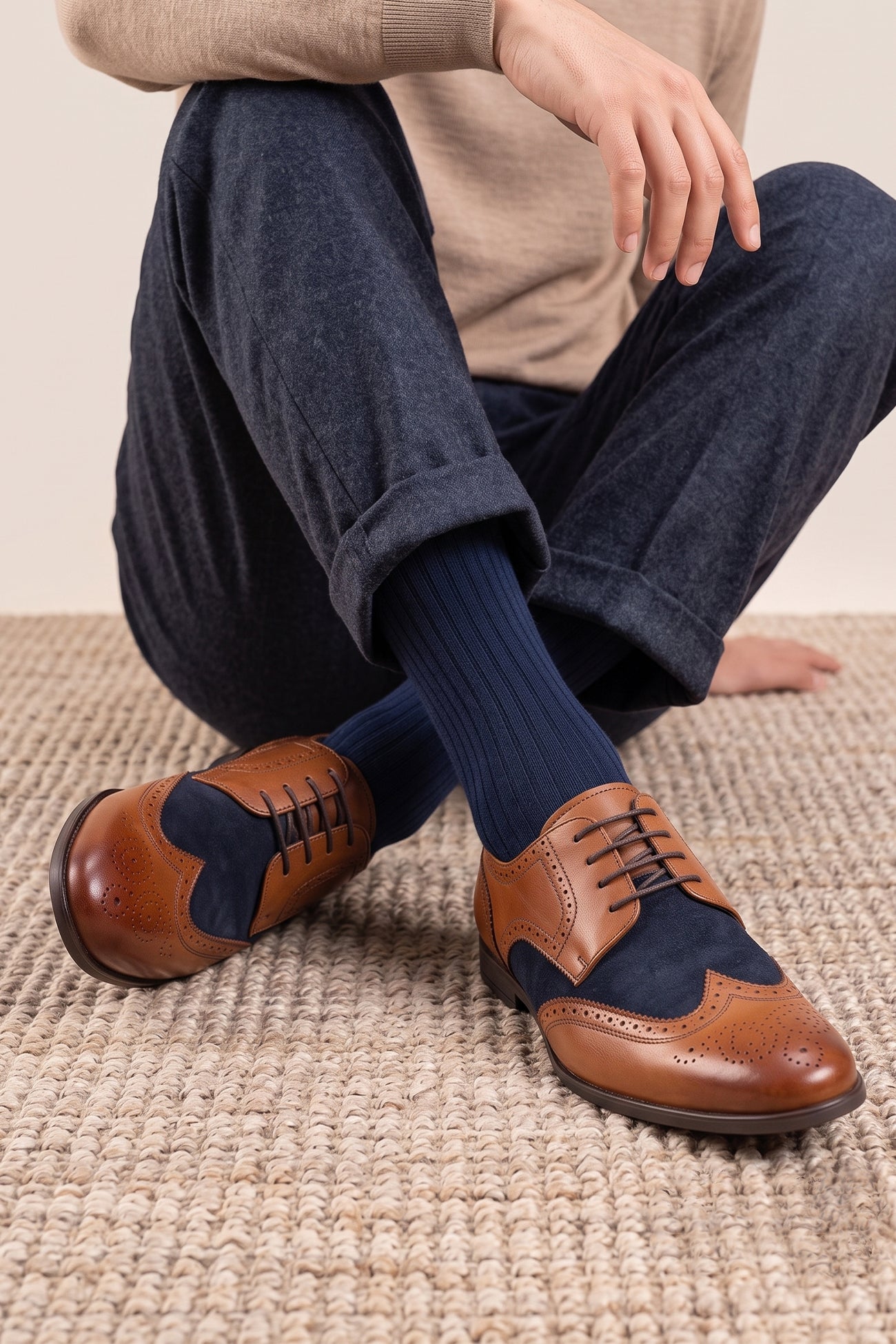 Model wearing Miller Tan Navy Suede men’s leather and  navy suede brogue shoes with wingtip detailing.