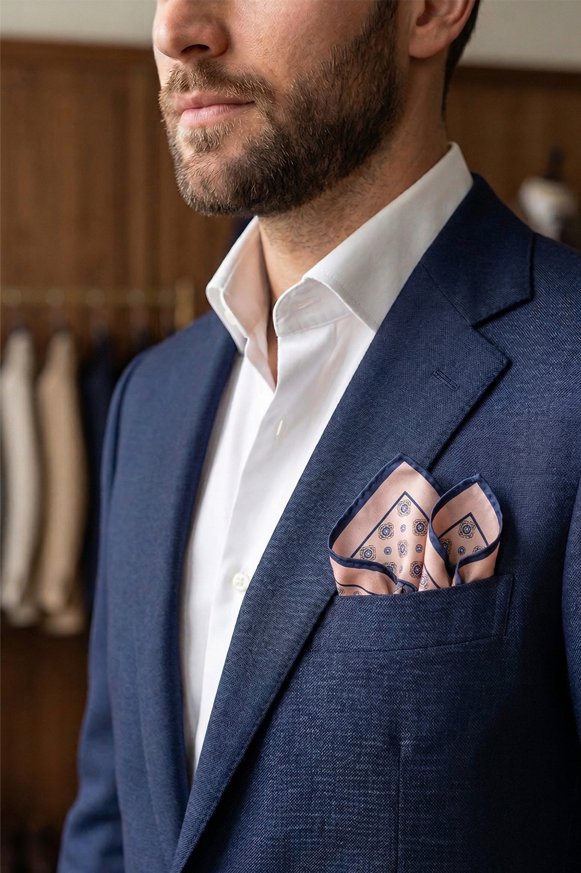 Salmon silk pocket square for men with intricate geometric pattern, crafted from luxurious silk for formal and smart-casual occasions.