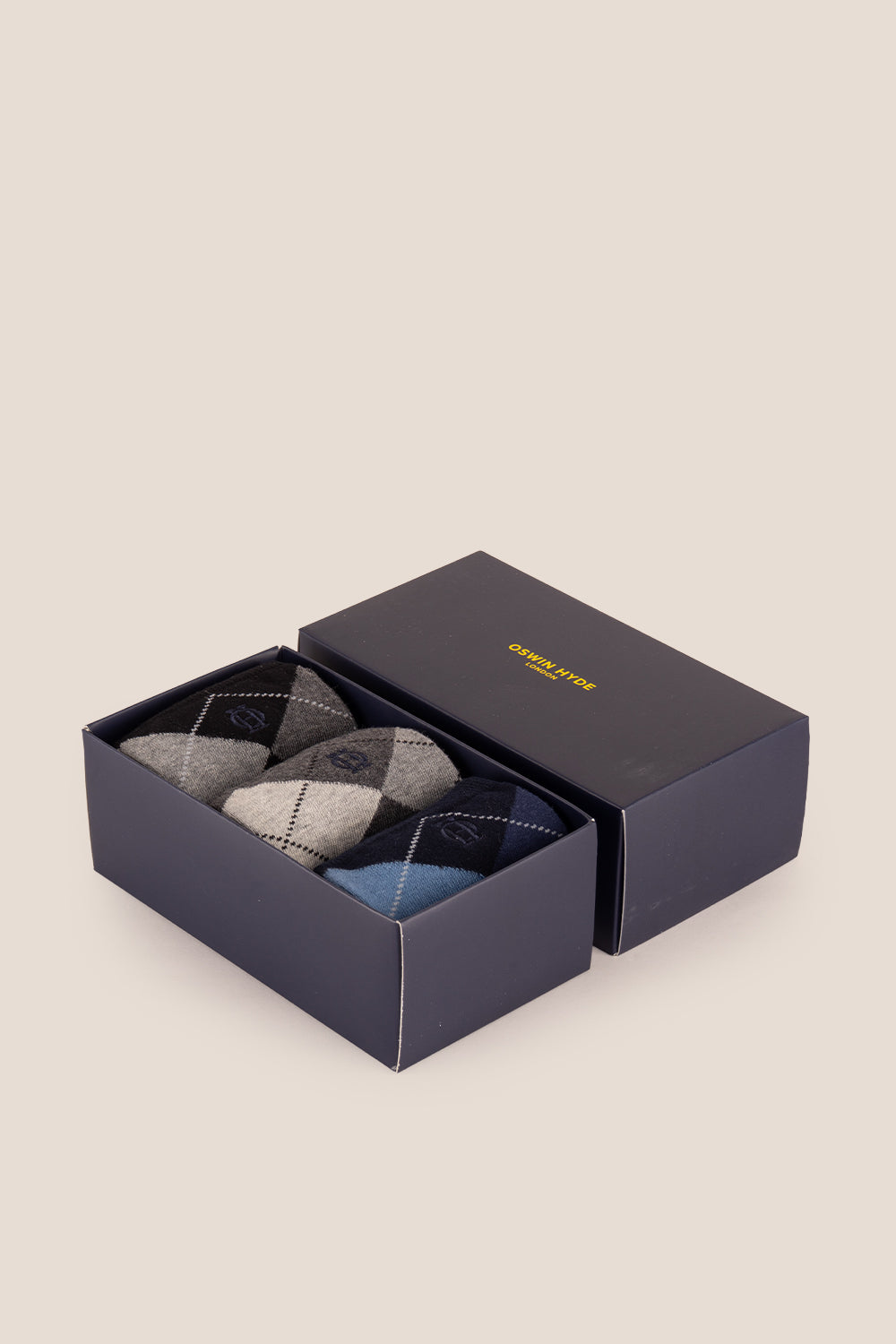 Three pairs of premium Scotch Argyle cotton socks designed by Oswin Hyde for the discerning gentleman.
