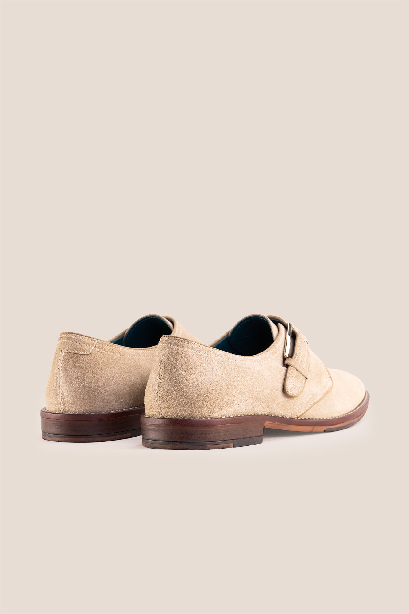 Premium men's sand suede single monk strap shoes by Oswin Hyde London, featuring a plain toe, adjustable silver buckle, contrast sole stitching, and a cushioned teal interior.