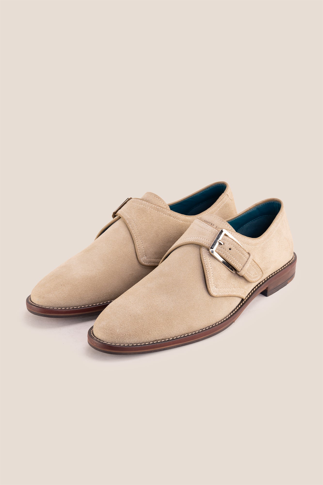 Premium men's sand suede single monk strap shoes by Oswin Hyde London, featuring a plain toe, adjustable silver buckle, contrast sole stitching, and a cushioned teal interior.