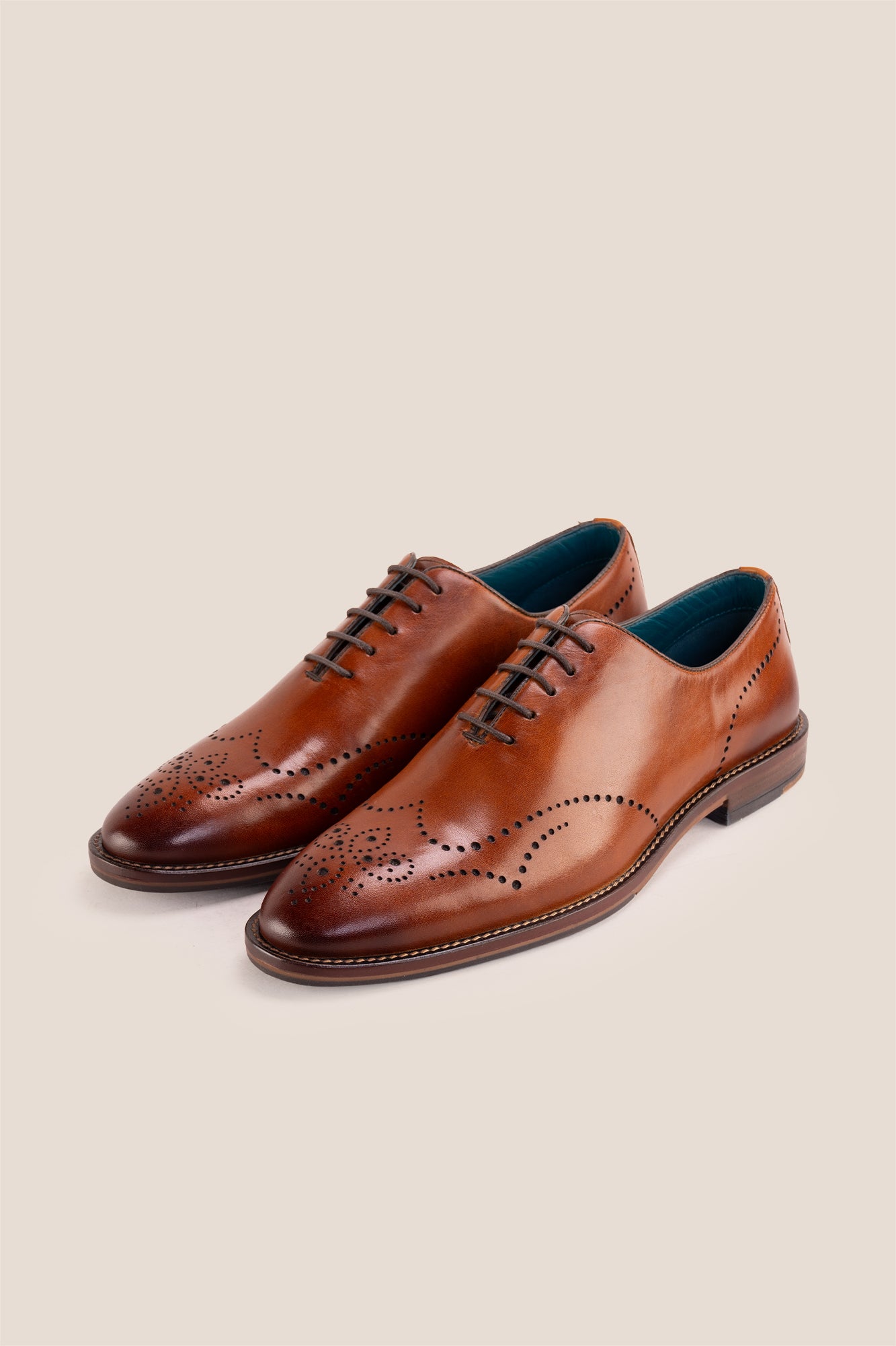 Oswin Hyde London premium Tan leather wingtip brogues with a toe medallion pattern, contrast welt stitching, and a cushioned teal interior.