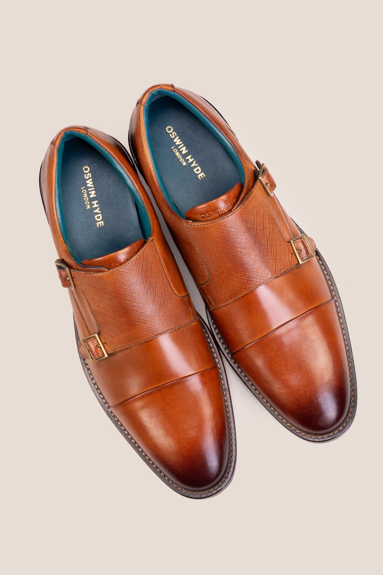 Kayden Tan leather monk strap shoes by OSWIN HYDE for men. Toe cap designed with saffiano print, cushioned insole and padded topline.
