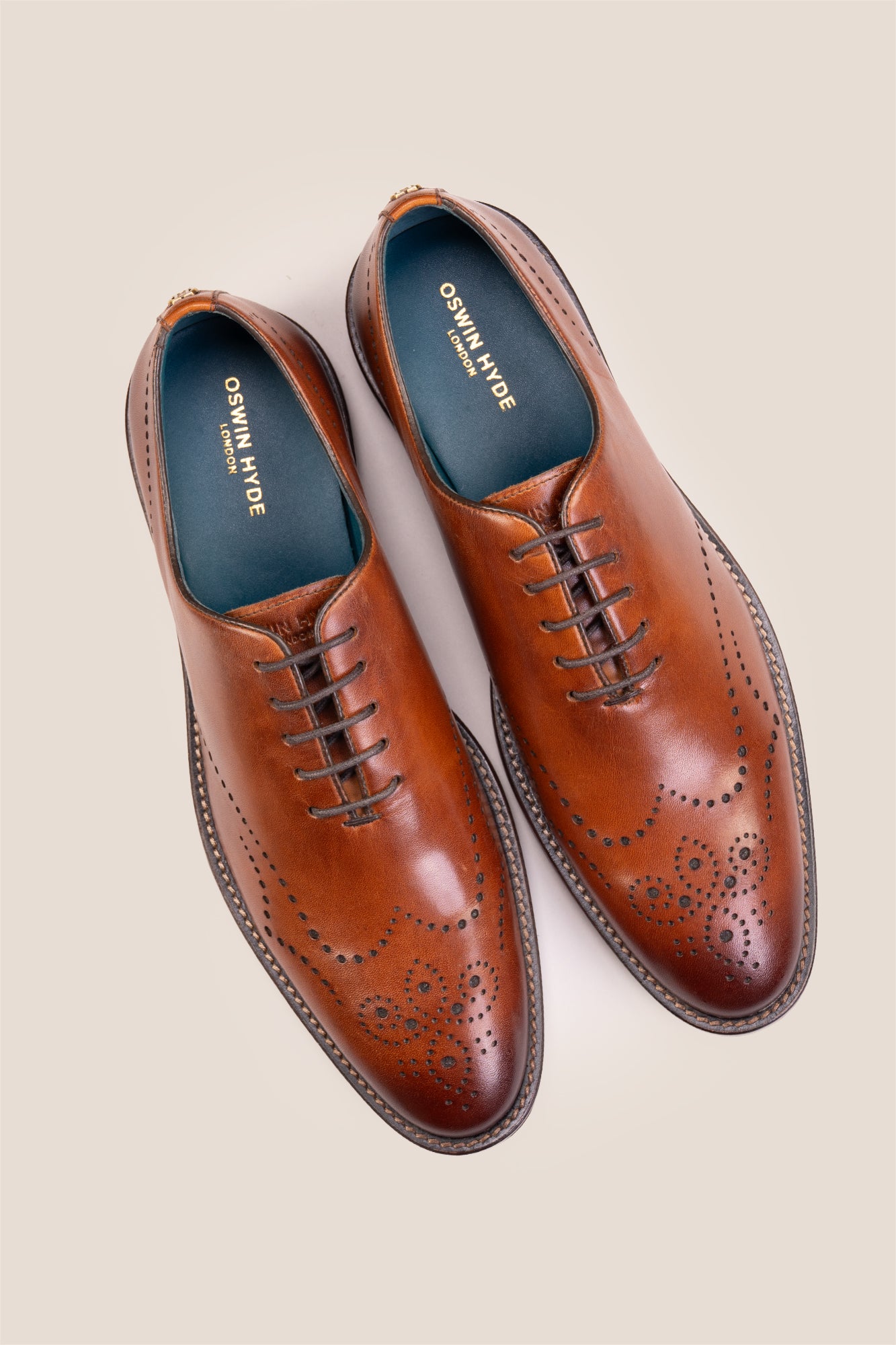 Oswin Hyde London premium Tan leather wingtip brogues with a toe medallion pattern, contrast welt stitching, and a cushioned teal interior.
