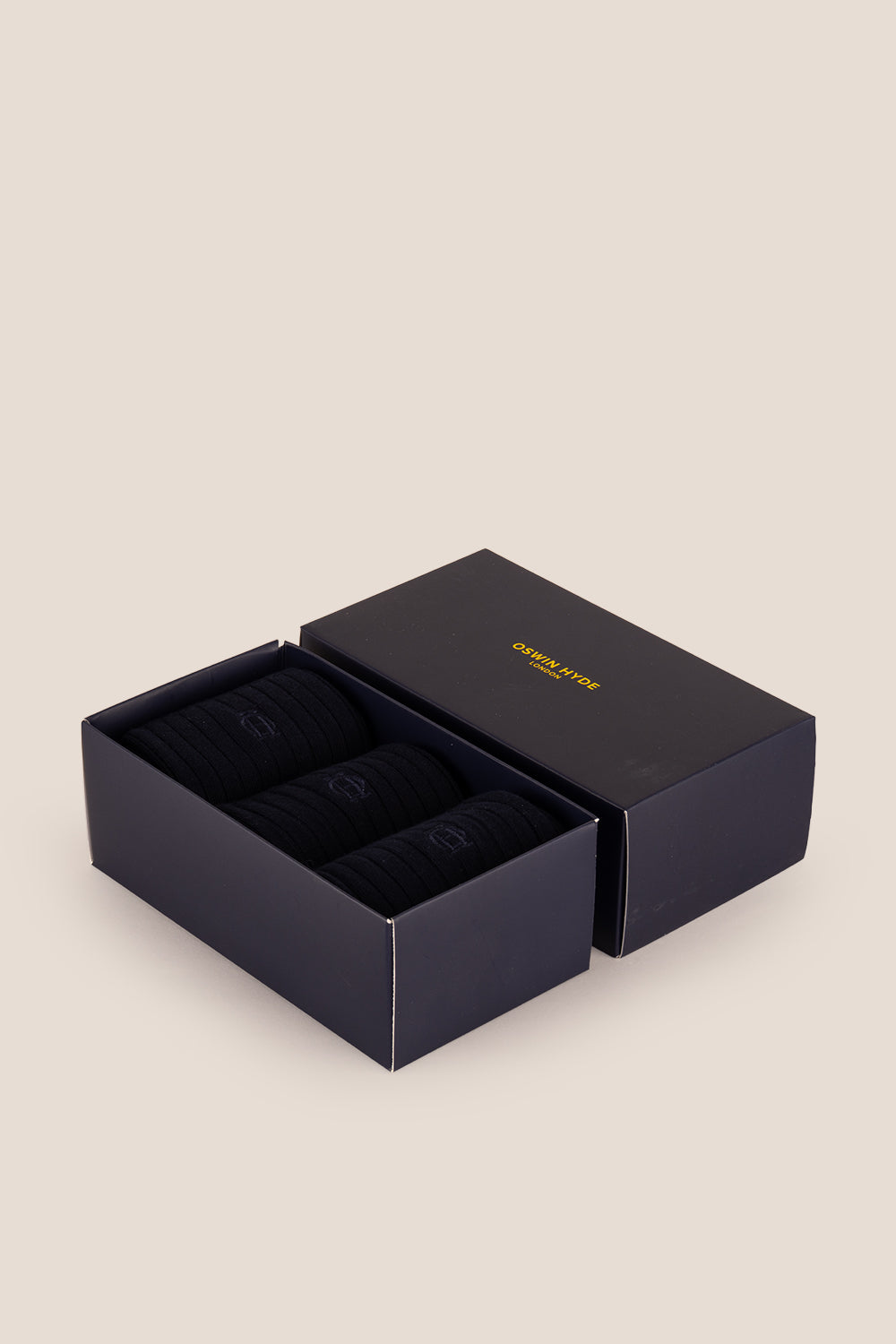 Three pairs of premium black cotton socks designed by Oswin Hyde for the discerning gentleman.