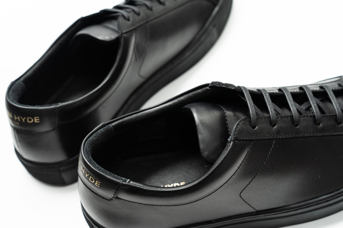 Men's black leather trainers with black sole