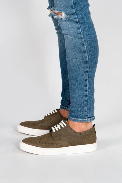 model wearing Men's khaki leather sneakers with white sole