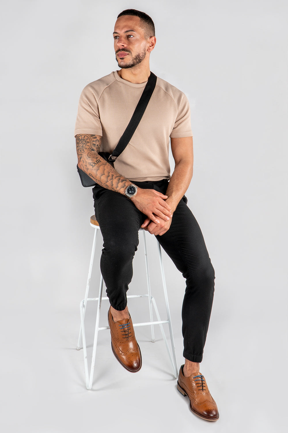 Model wearing beige shirt and tan leather brogue 