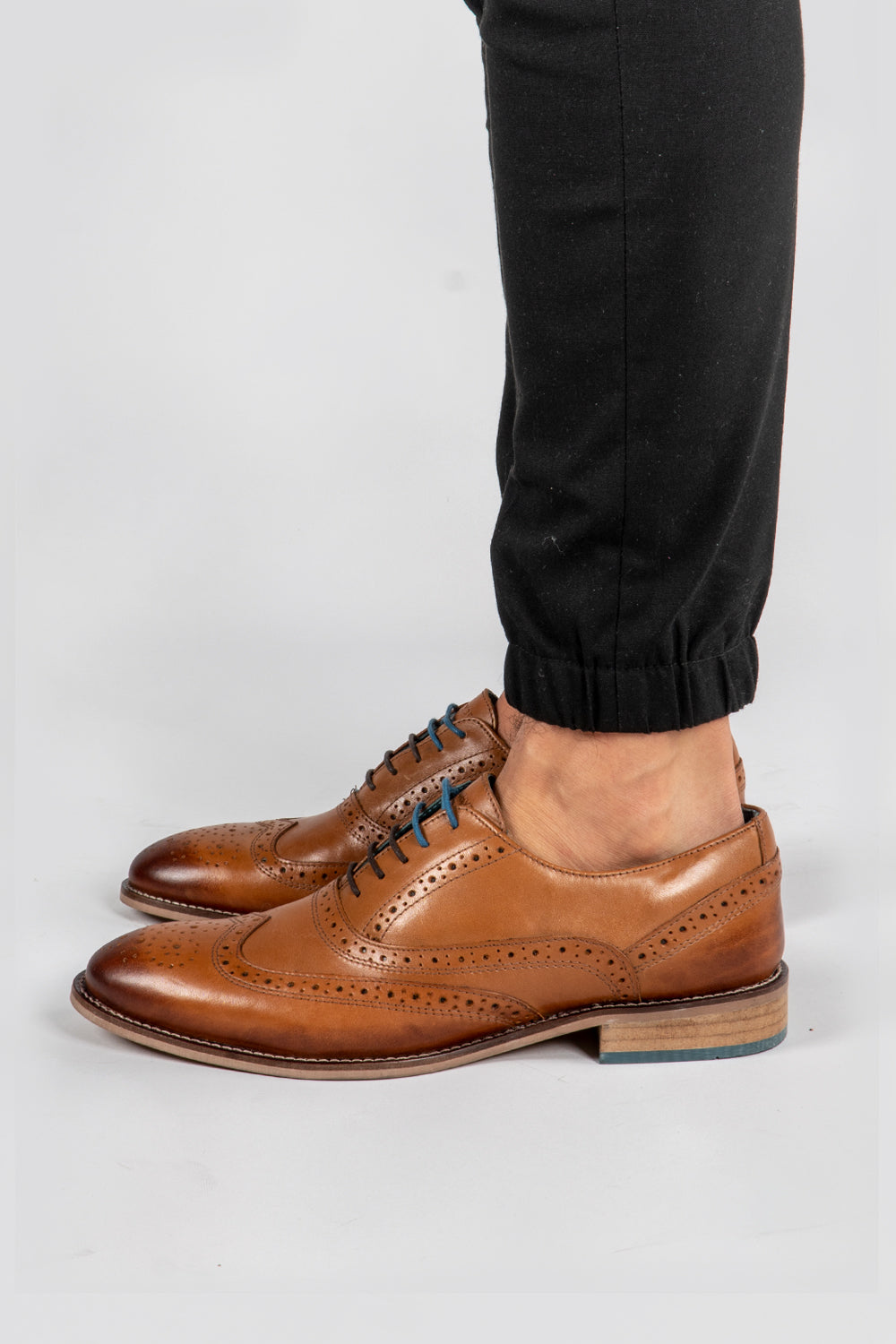 Man wearing tan leather brogue shoes Winston tan brogue wingtip oxford shoes for men by oswin hyde
